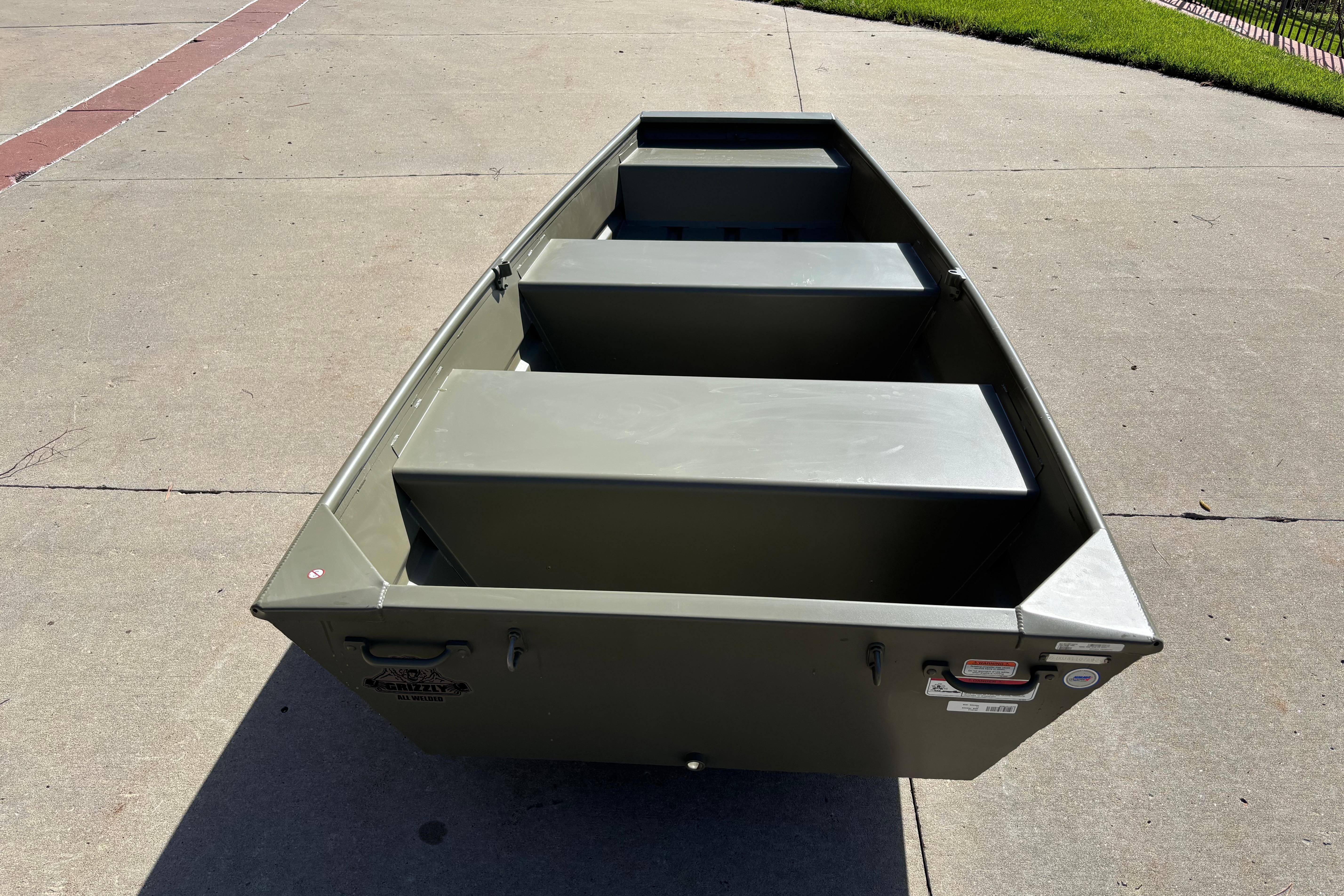 2026 Tracker Grizzly 10 Jon boat on concrete surface, showcasing its sturdy design.