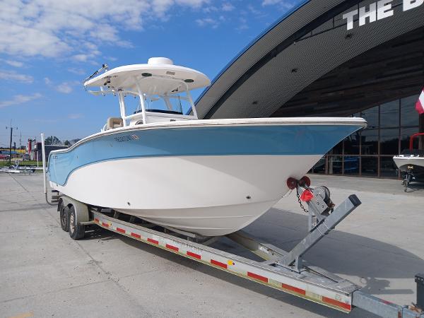 2015 Sea Fox 286 Commander boat on trailer, parked outside a building.