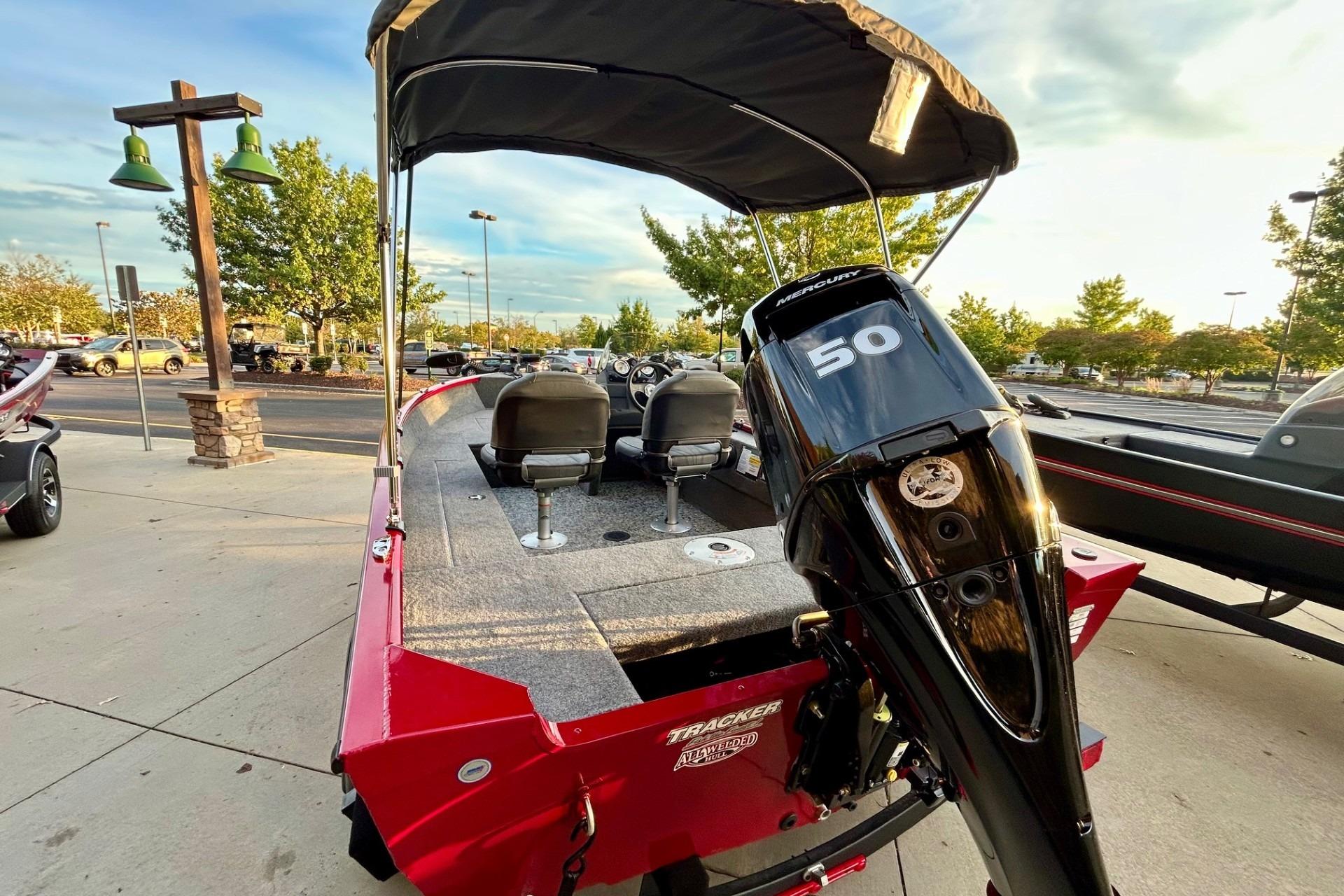 2026 Tracker Super Guide V-16 SC boat with Mercury 50 engine, parked outdoors.