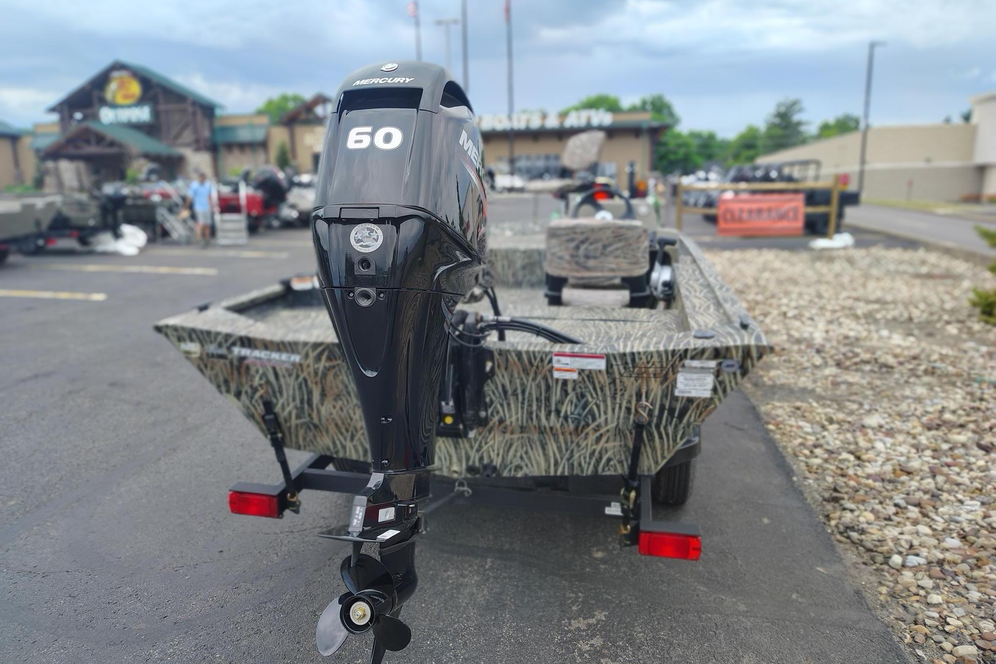 2026 Tracker Grizzly 1754 SC boat with Mercury 60 outboard motor in parking lot.