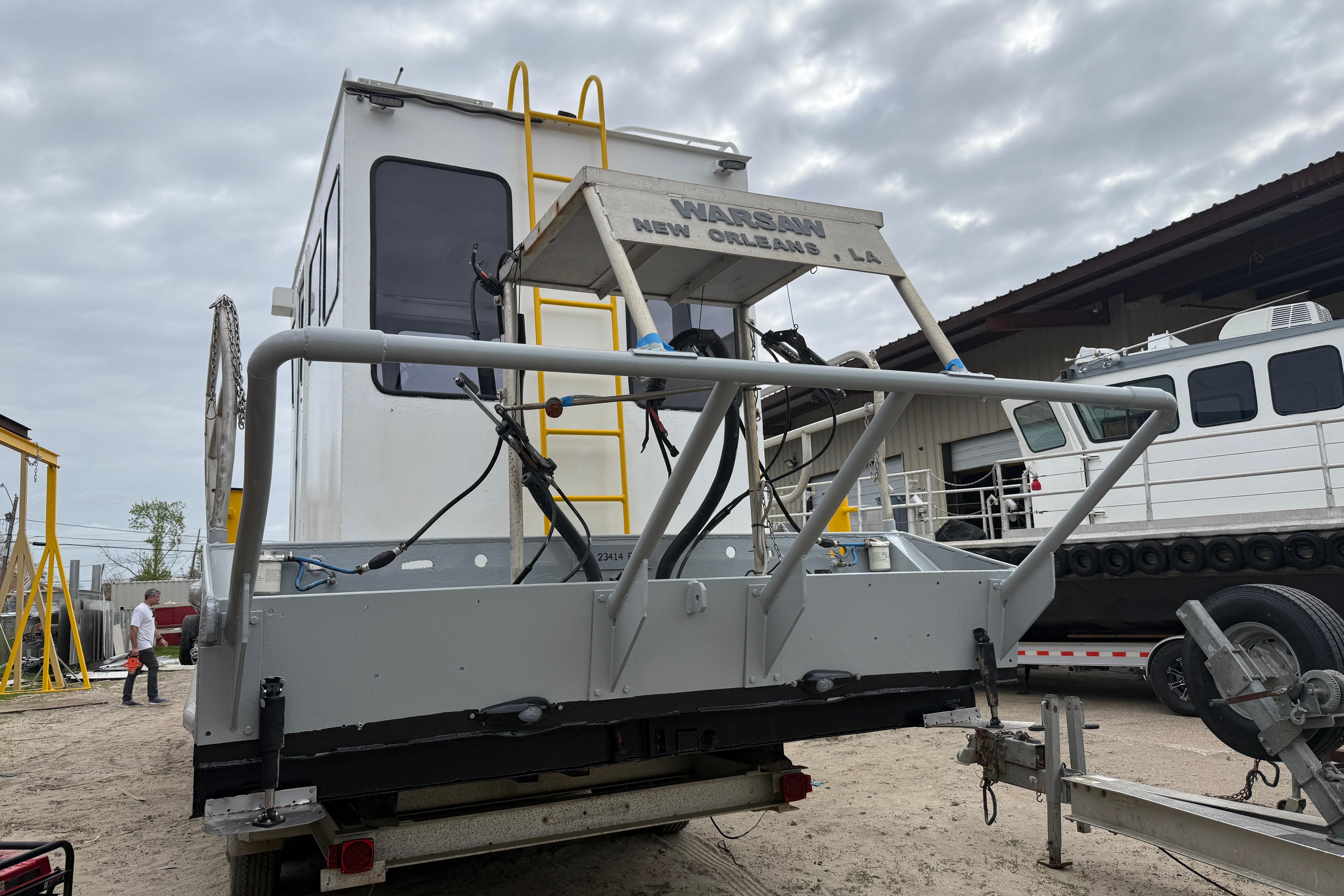Custom Aluminum Work Boat 34x10, 2010 model, docked with visible equipment and ladder.
