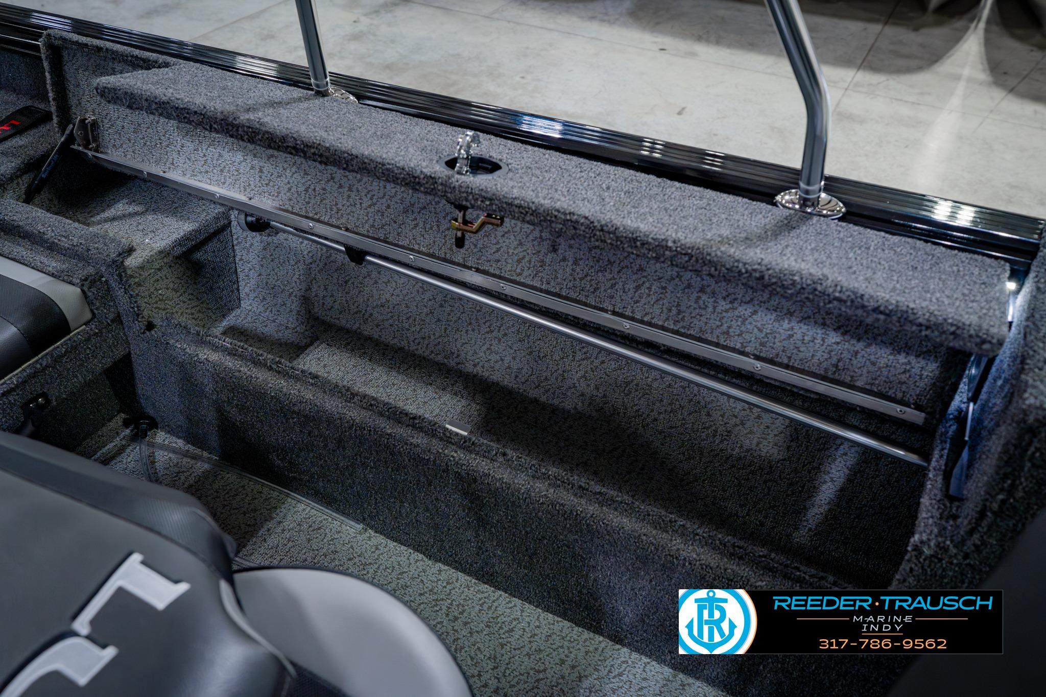 Interior view of 2026 Lund 1875 Impact XS boat, featuring storage compartment and seating.