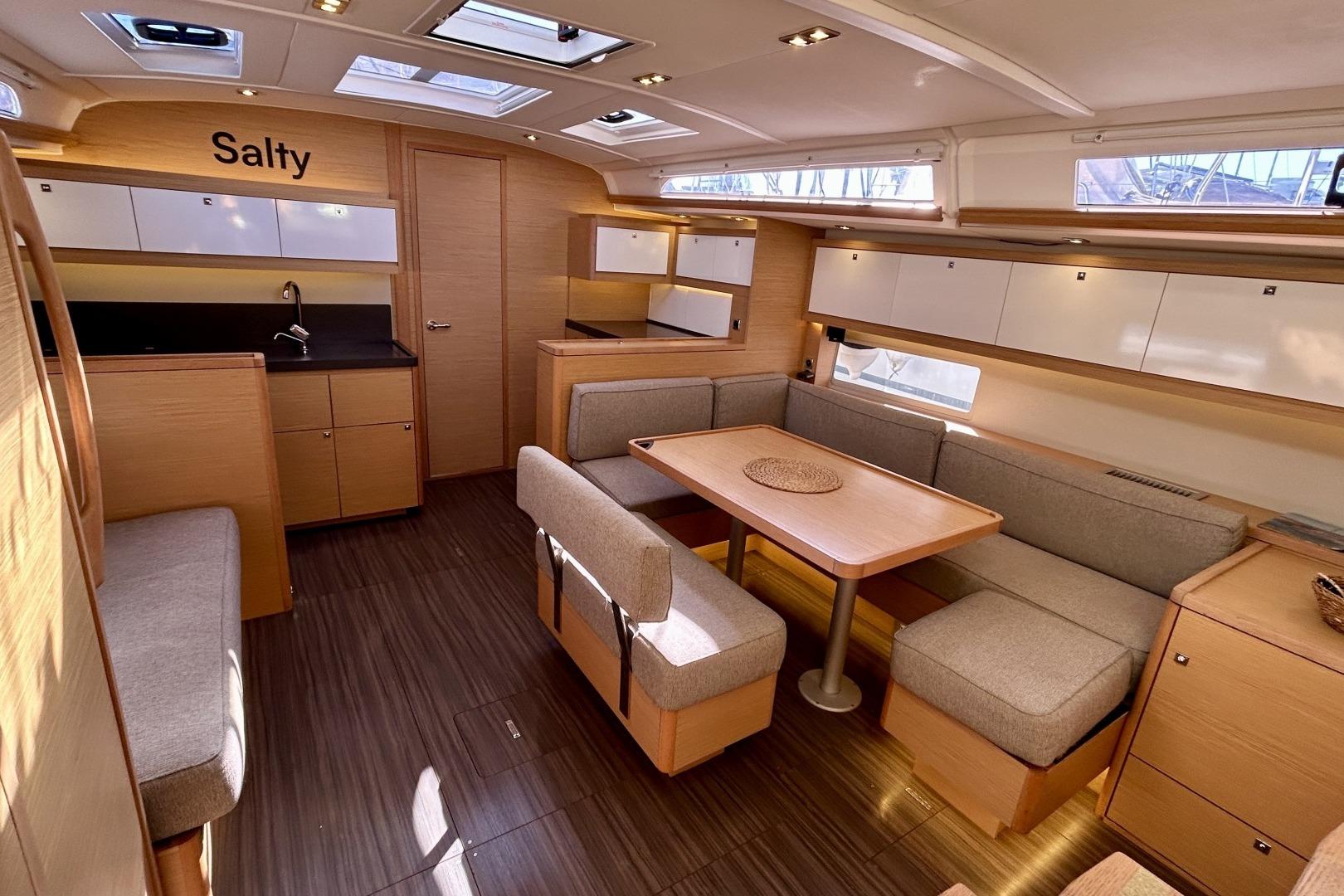 Modern interior of 2022 Dufour 470 yacht with spacious seating and sleek design.