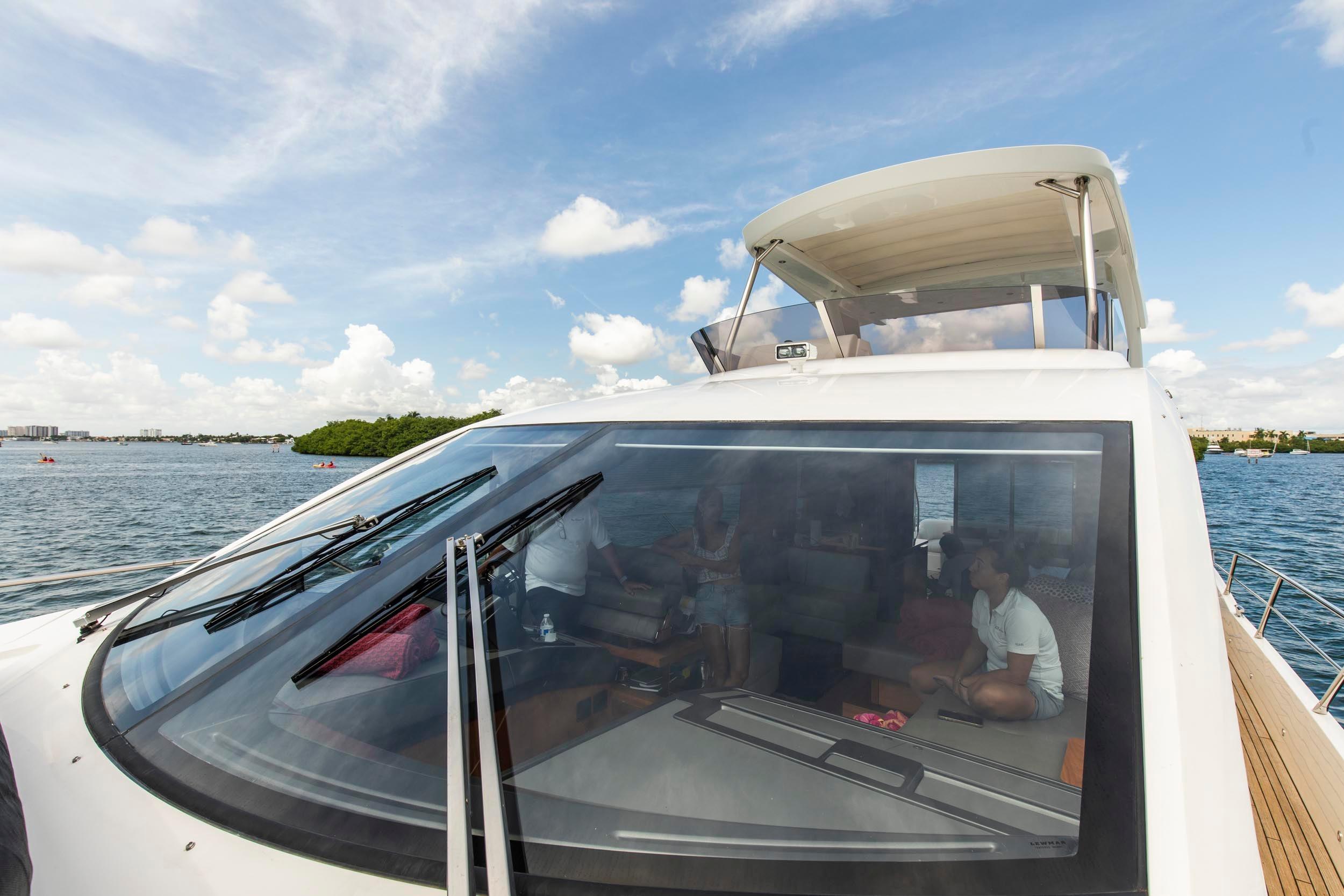 2021 Sunseeker Manhattan 68 yacht on water, showcasing sleek design and spacious interior.
