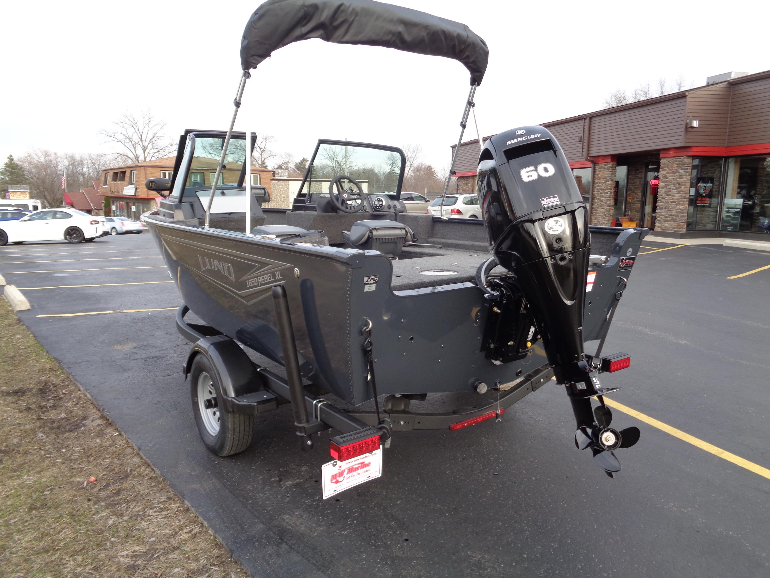2024 Lund 1650 Rebel XL Sport boat with 60 HP motor in parking lot.