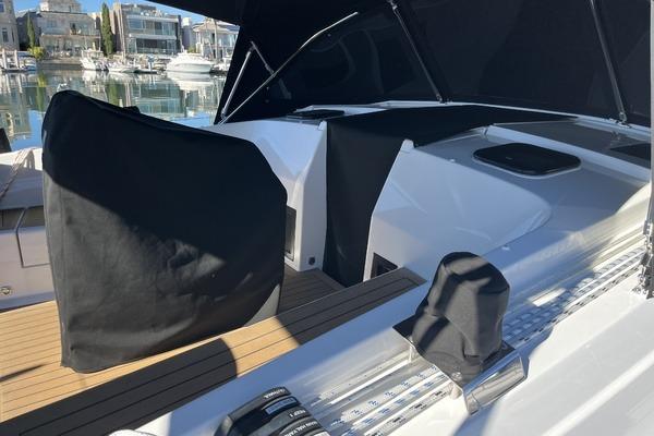 2025 Hanse 360 yacht deck with covered controls, docked in a marina.