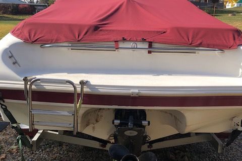 1999 Rinker 212 Fiesta Vee boat with red cover.