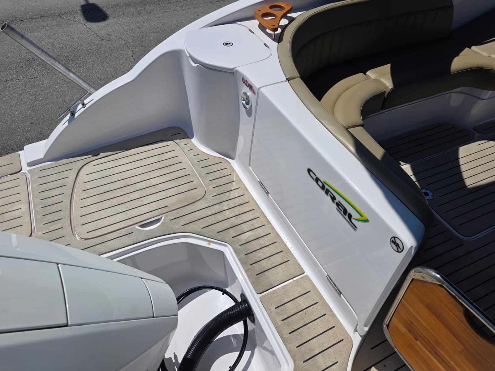 The image shows the stern of a Coral 26 boat with modern design and comfortable seating.