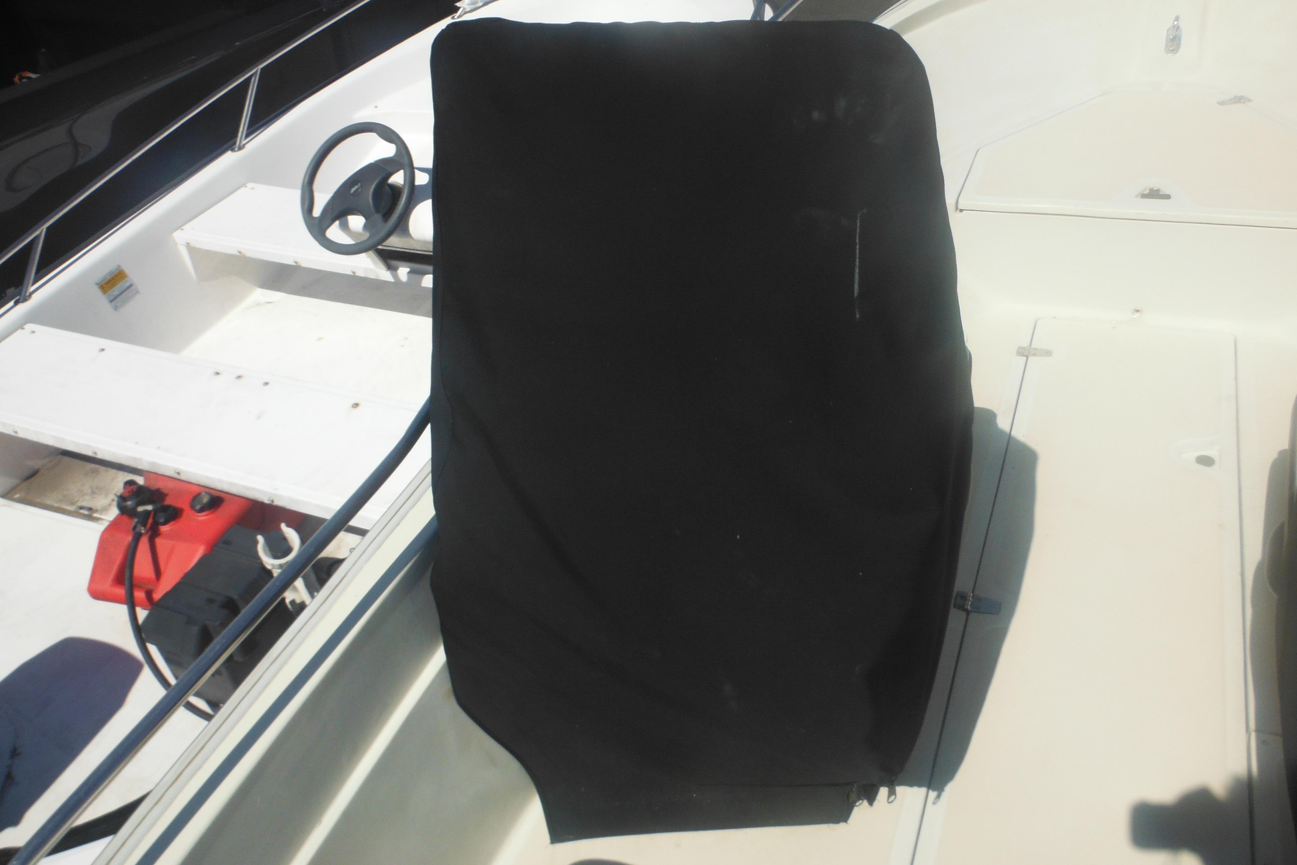 1991 Boston Whaler 16 SL boat interior with covered console and steering wheel.