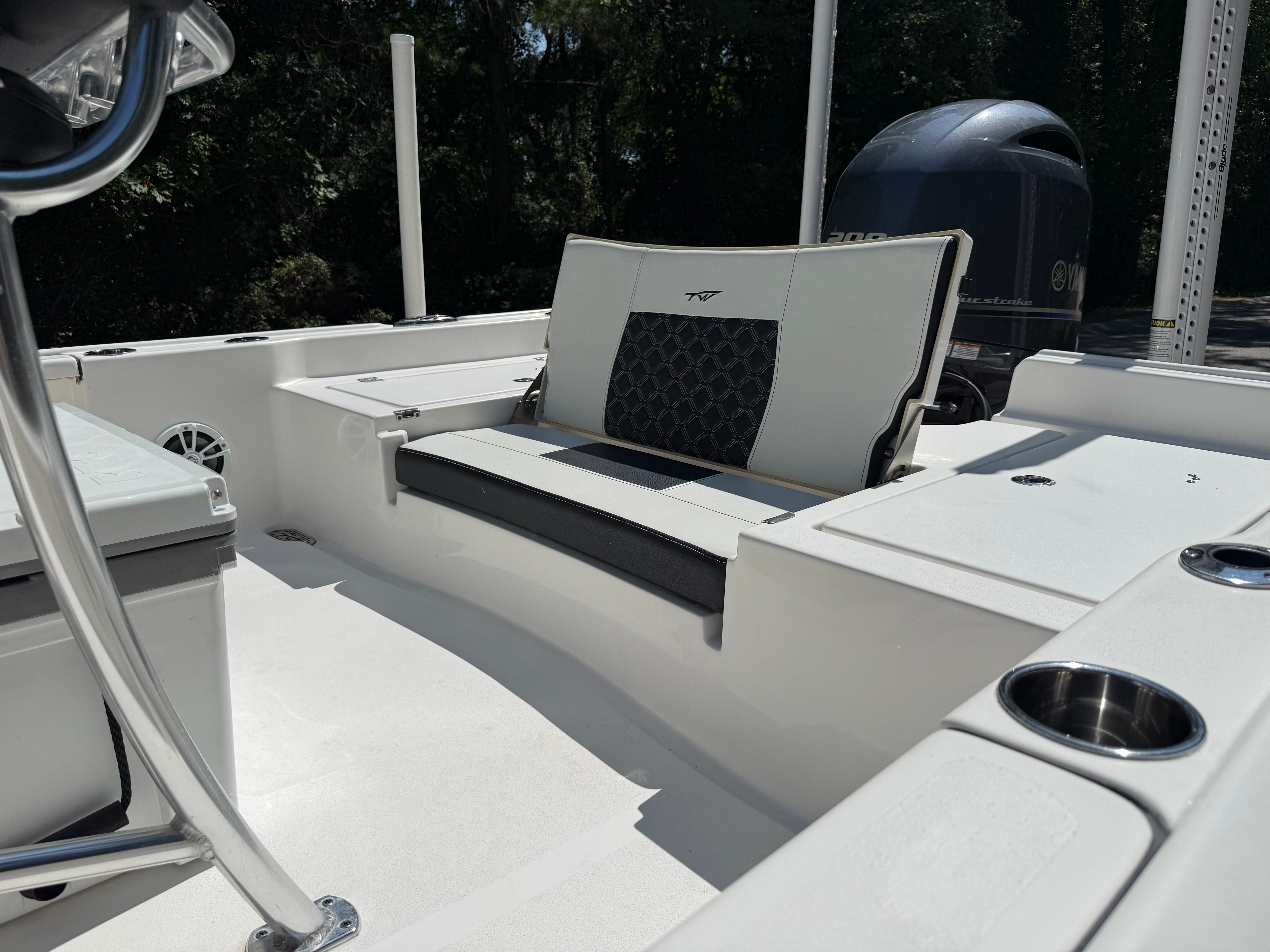 The image shows the cockpit of a 2023 Tidewater 2210 Carolina Bay boat with seating and motor.