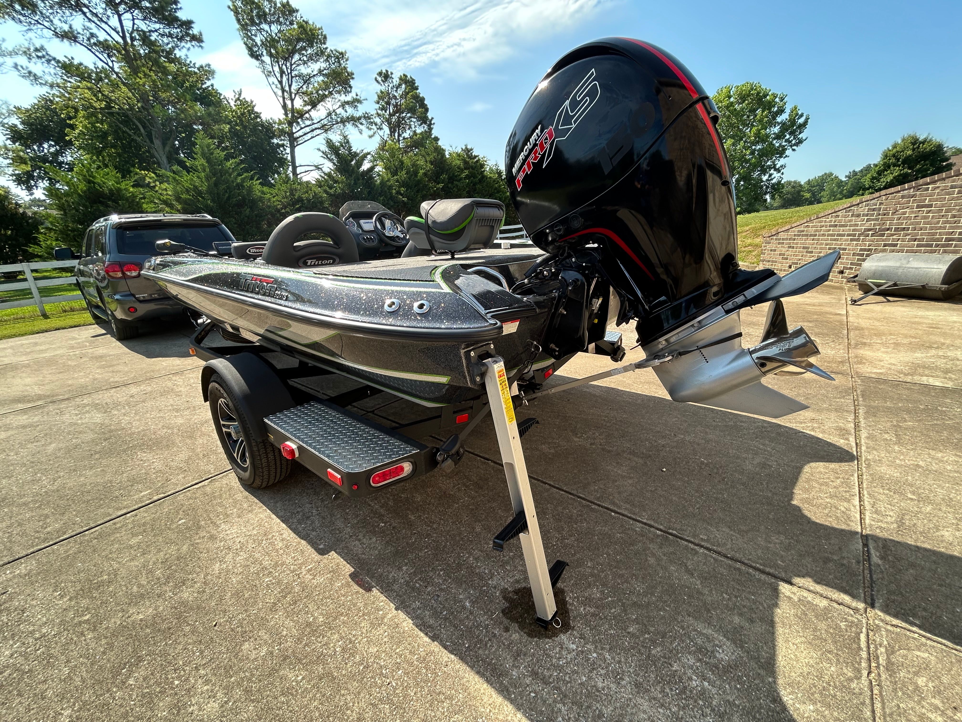 A 2020 Trident 189 TRX boat on a trailer. It features a large outboard motor.