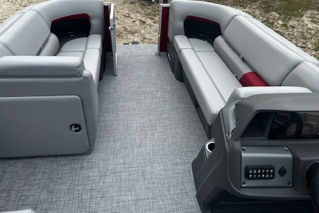 2026 Sun Tracker Party Barge 20 DLX interior with gray seating and modern dashboard.
