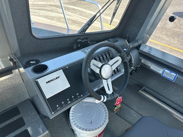 2024 Spartan 260 Maximus Pro XL boat cockpit with steering wheel and Mercury controls.