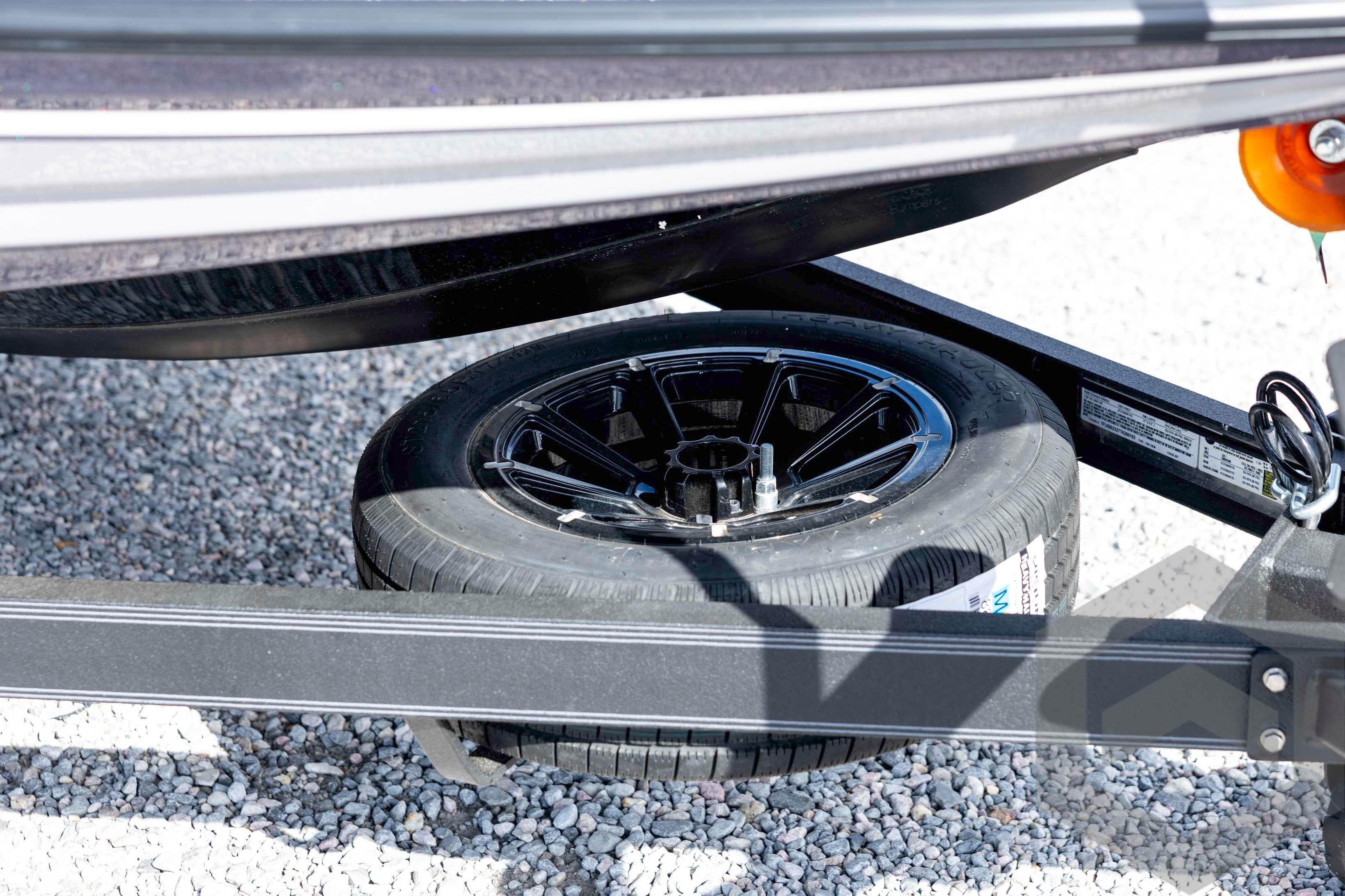 2026 Skeeter FXR20 FLEX trailer with spare tire on gravel surface.