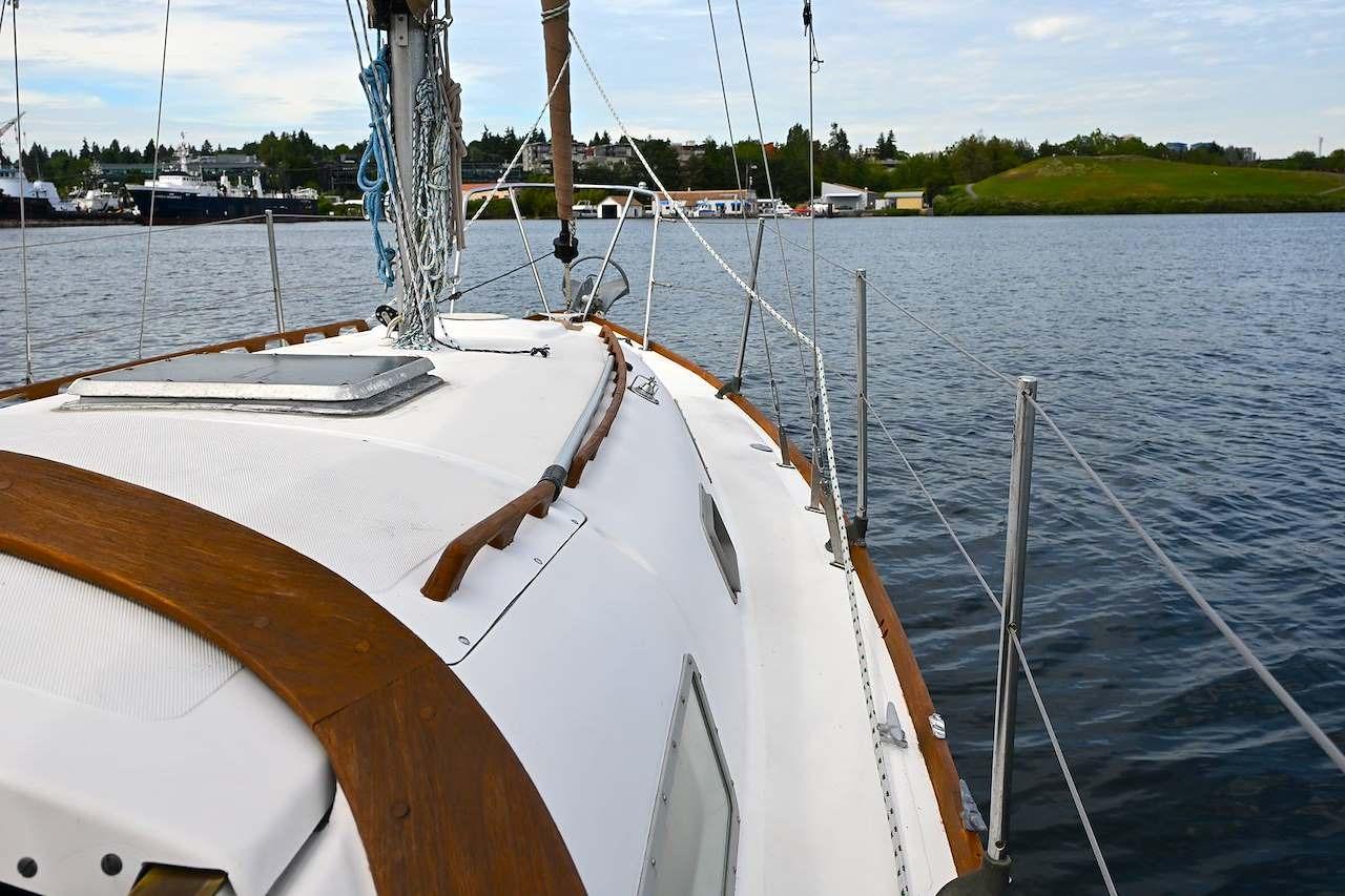 1977 Mercator Offshore sailboat on calm water, showcasing deck and rigging.
