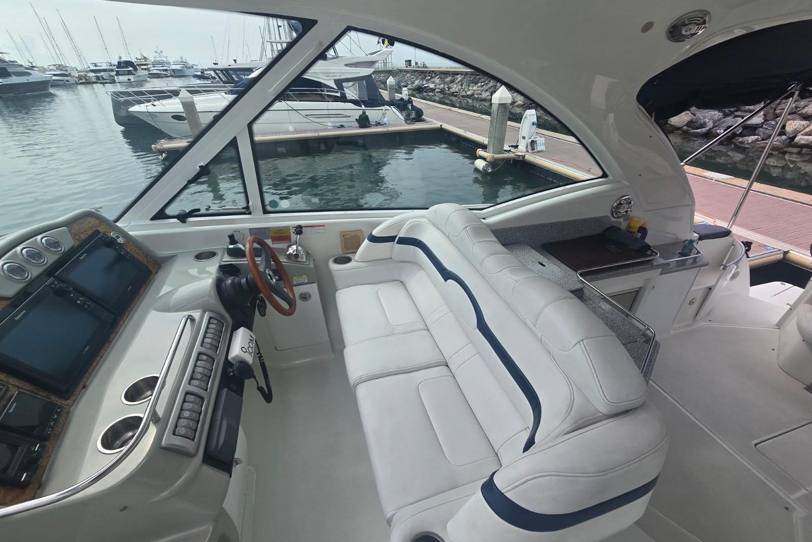 Interior view of 2011 Formula 45 Yacht at marina, featuring helm and seating area.