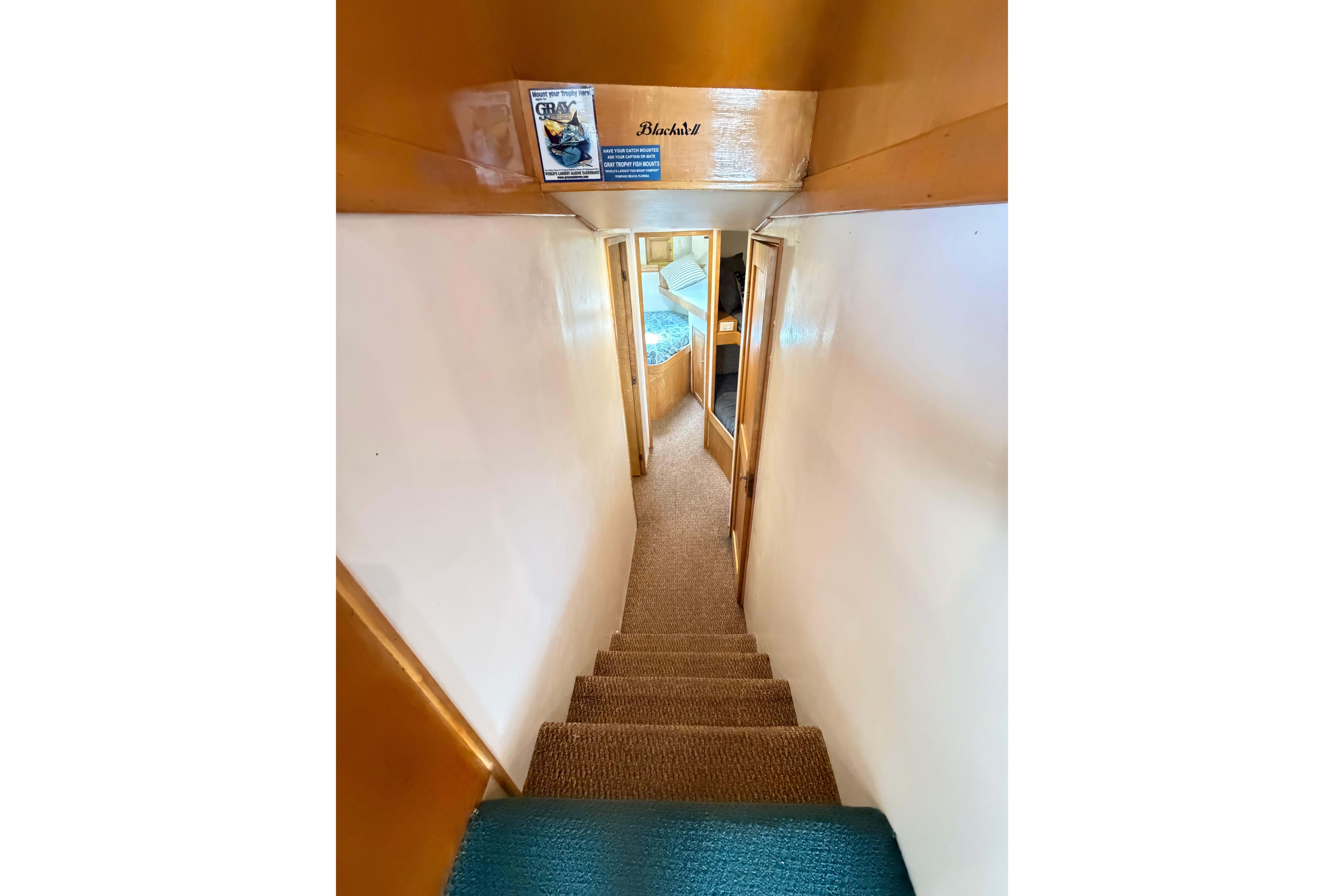 Interior view of 1998 Blackwell Custom Carolina Sportfish, featuring narrow carpeted stairs.