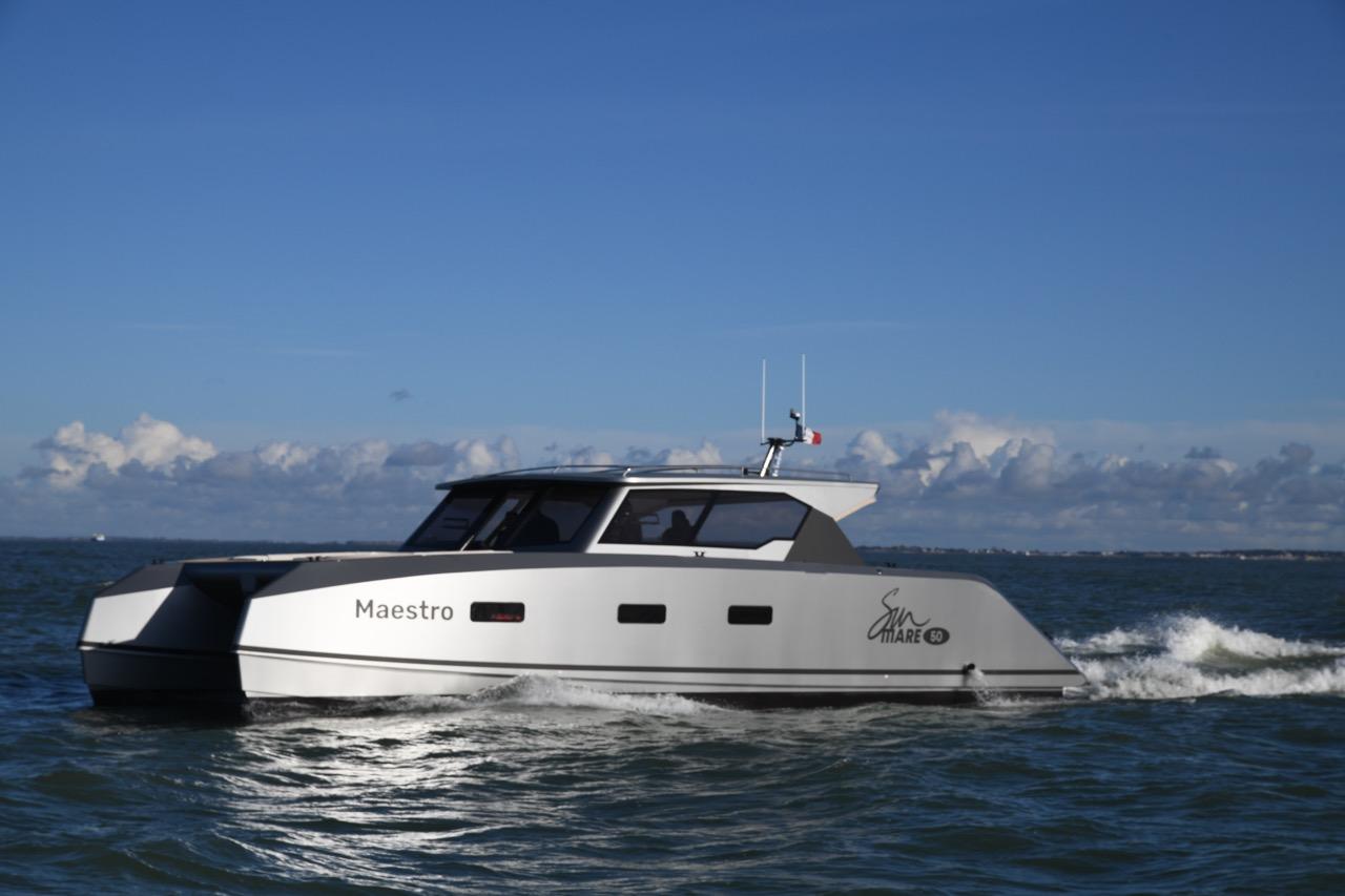 2024 Custom Sunmare 50 Hybrid Catamaran cruising on open water.