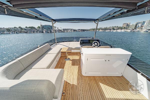 2025 Sunseeker Manhattan 68 yacht interior with seating, helm, and ocean view.