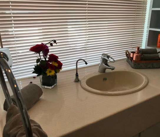 Luxurious bathroom sink with flowers and towels on a 2006 Custom Motorsailer.