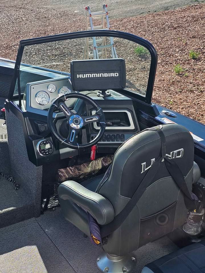 Interior of a Lund 1975 Tyee boat with steering console, 2020 model.