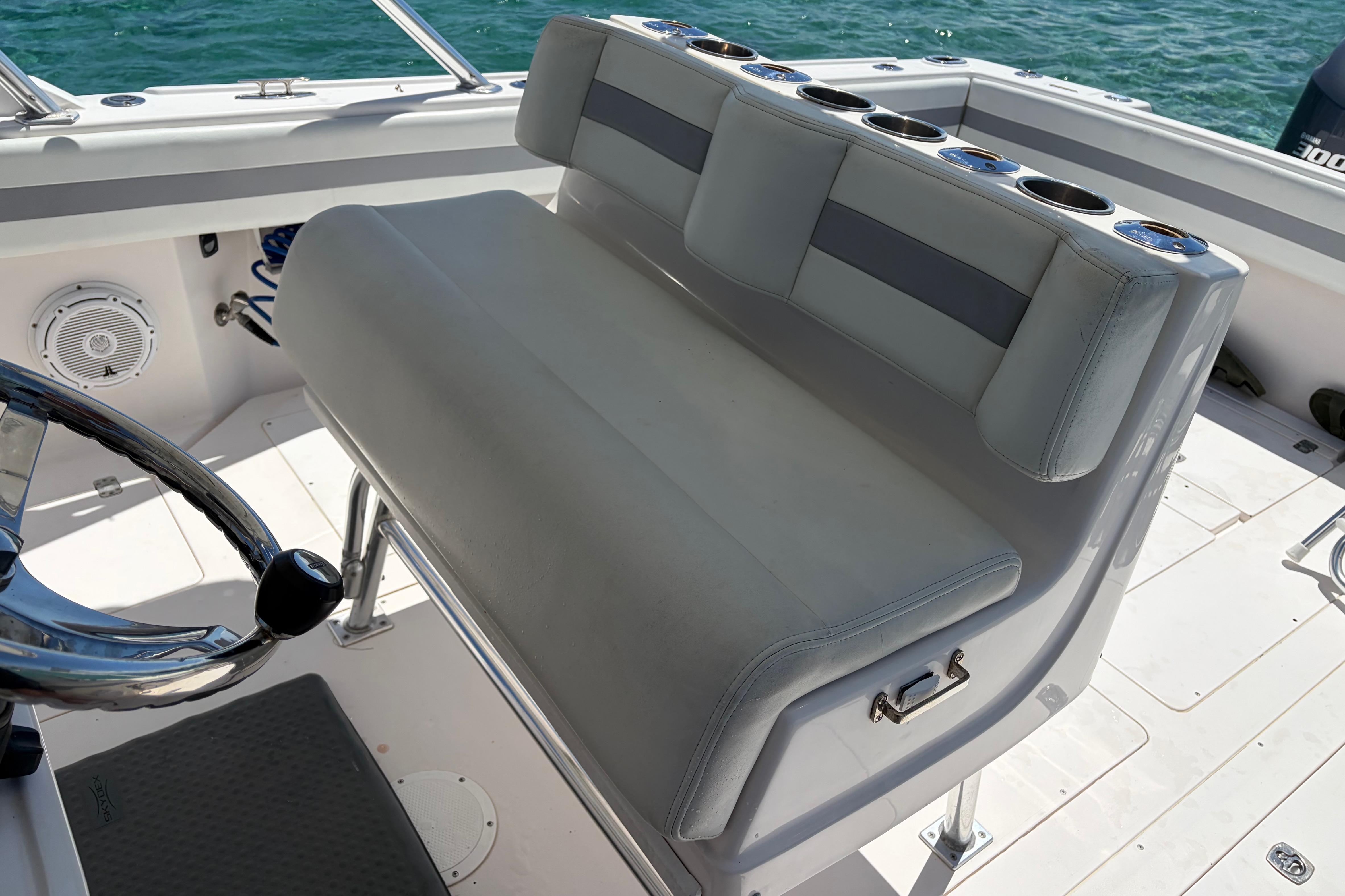 1998 Intrepid 339 Walkaround boat interior with steering wheel and cushioned seating.