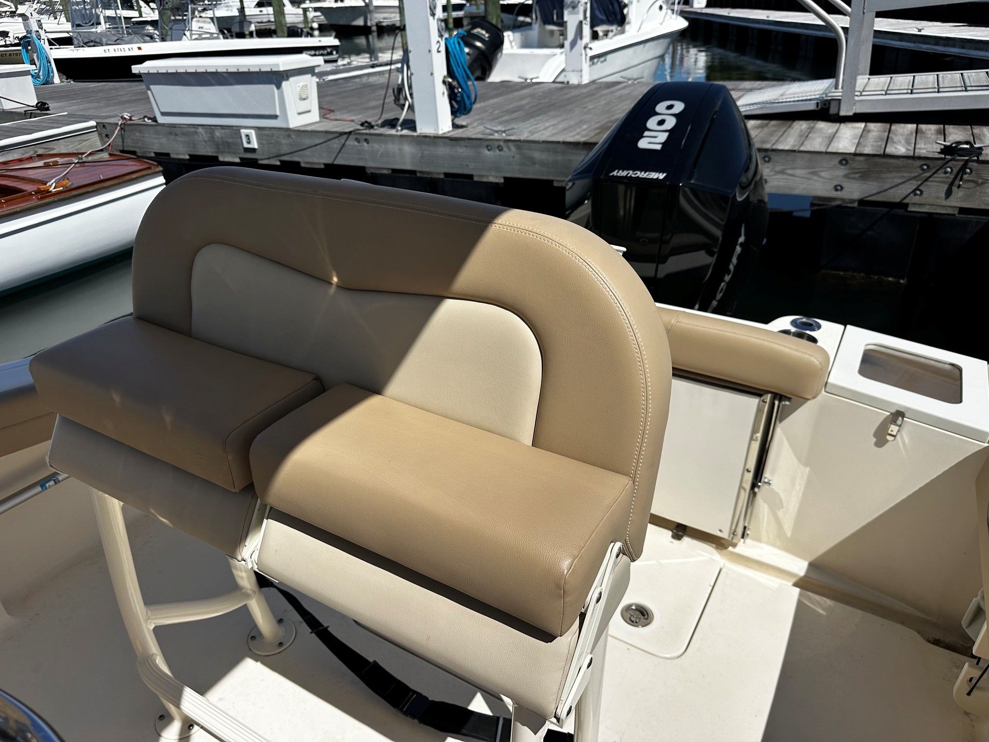 Scout 210XSF 2022 boat with beige seating at dock.