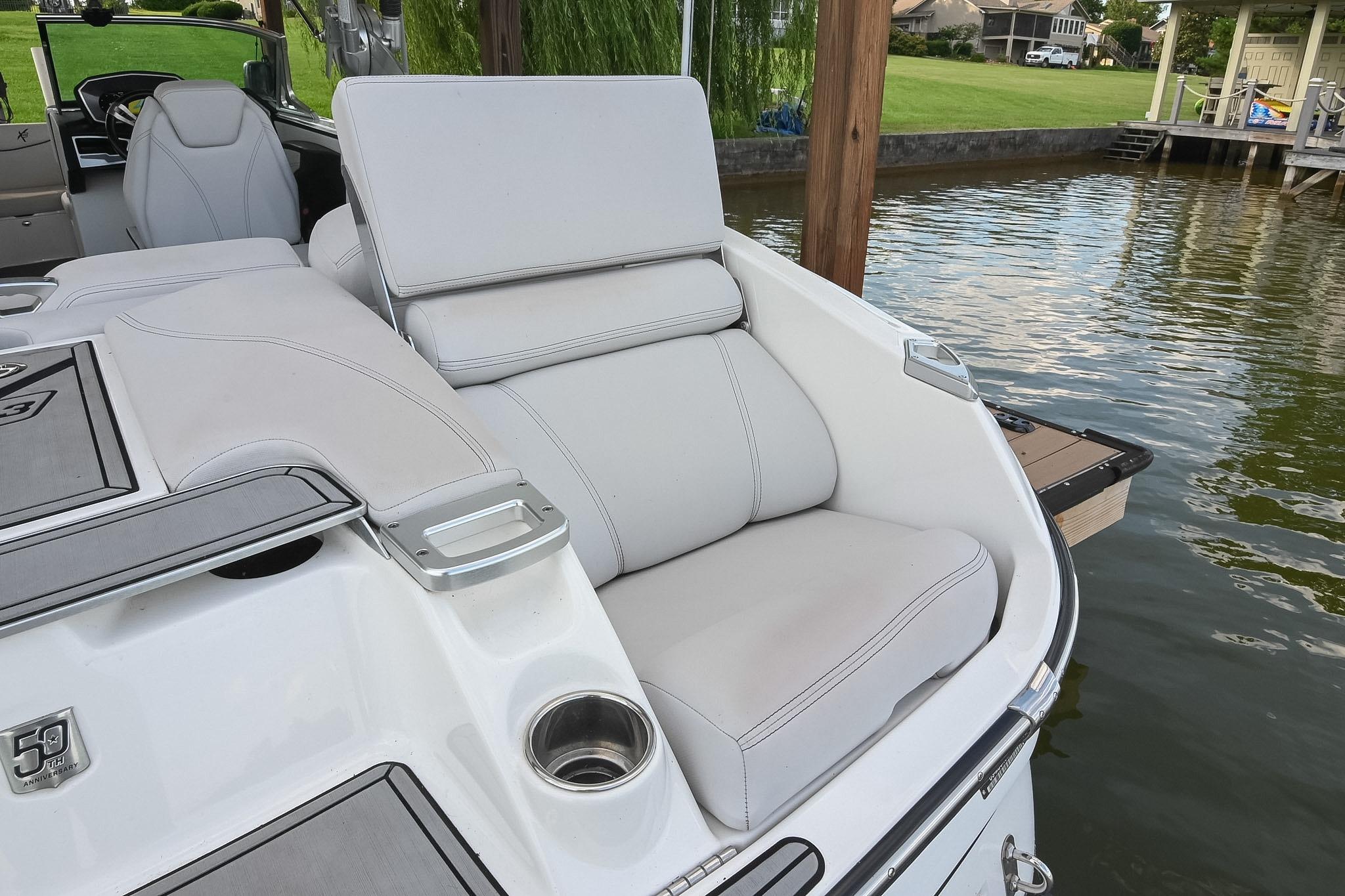 2018 MasterCraft X23 boat with luxurious seating by the water.