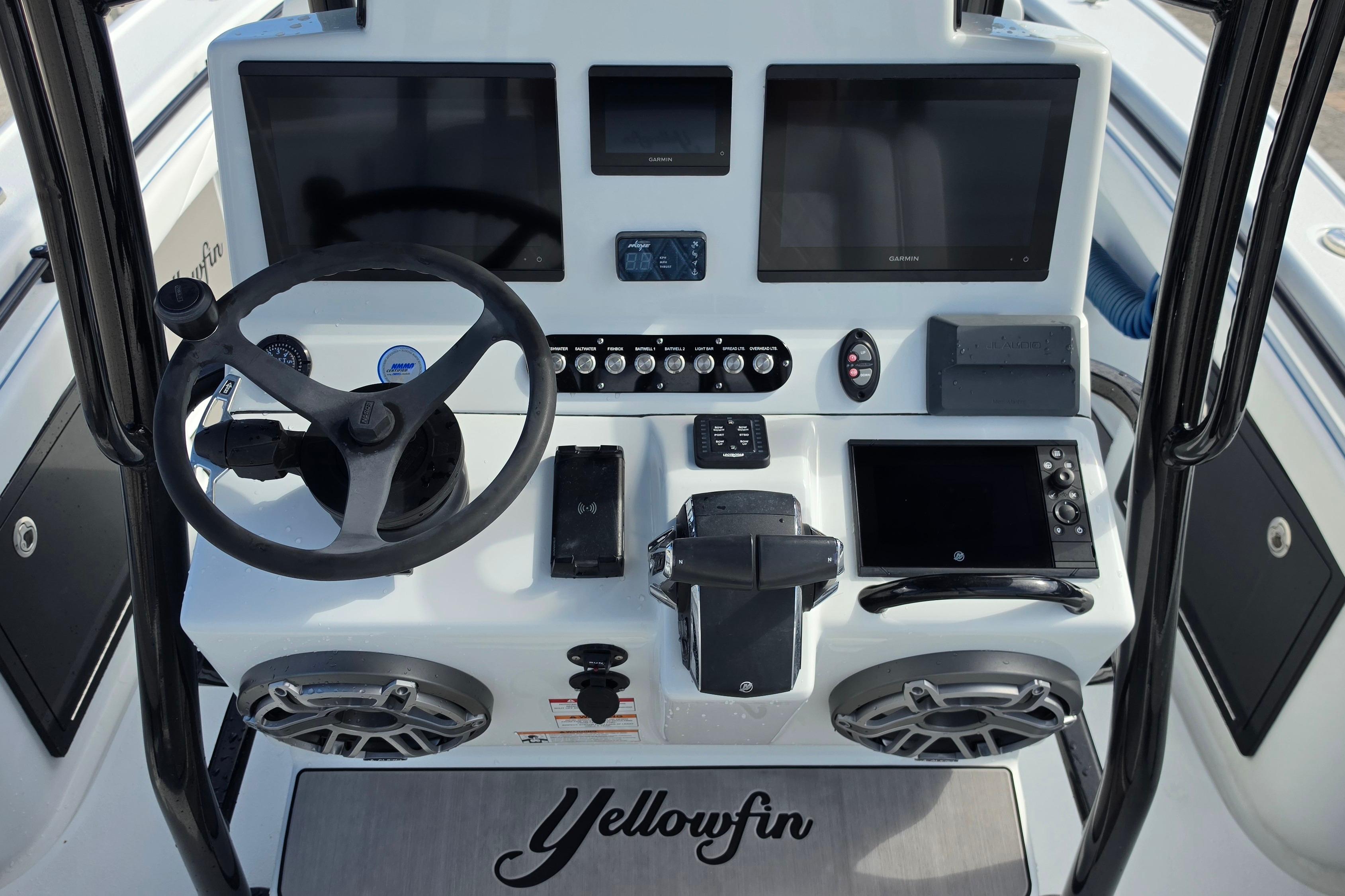 2025 Yellowfin 26 Hybrid boat dashboard with steering wheel and electronic displays.