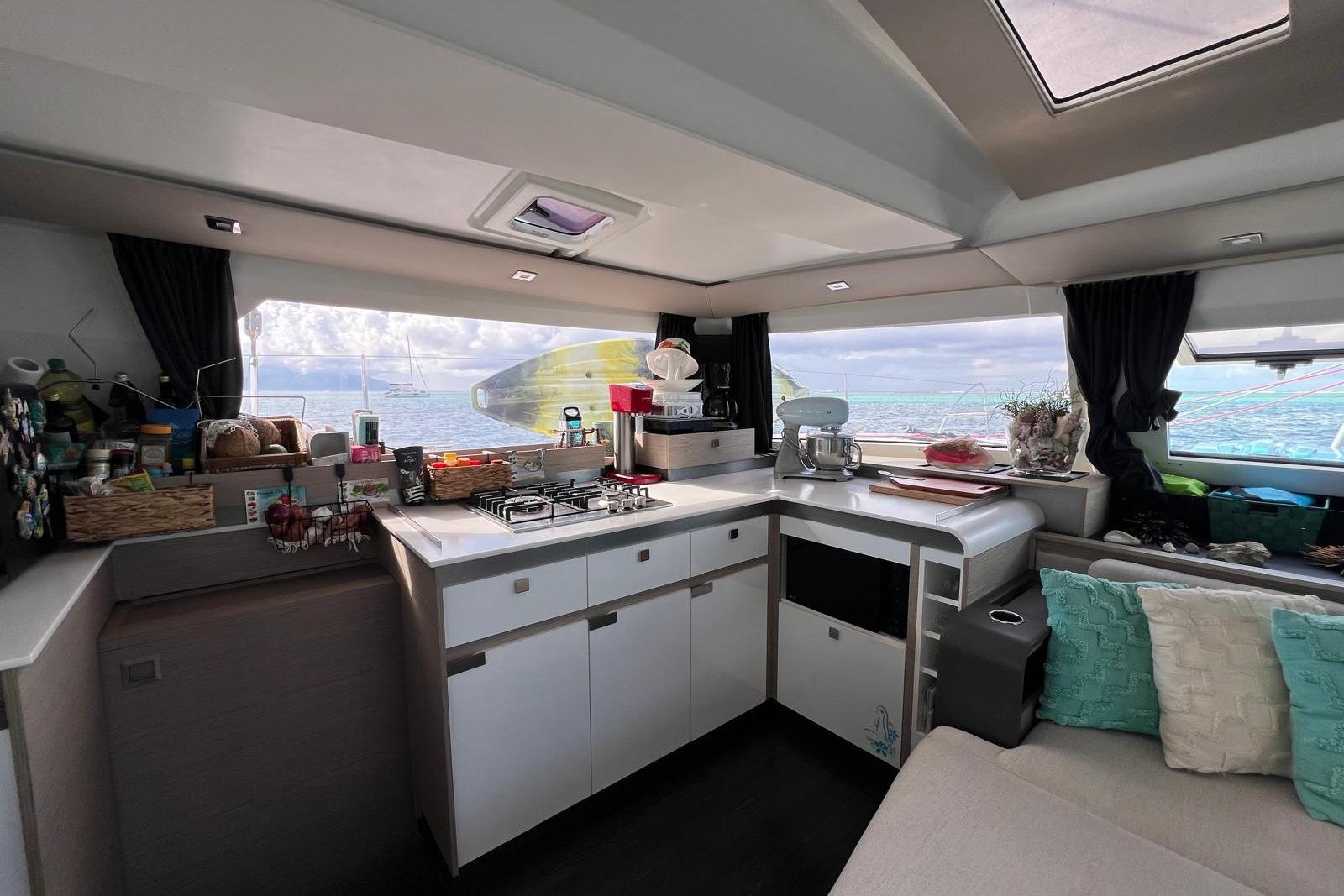 Modern kitchen interior of 2022 Fountaine Pajot Elba 45 Catamaran with ocean view.