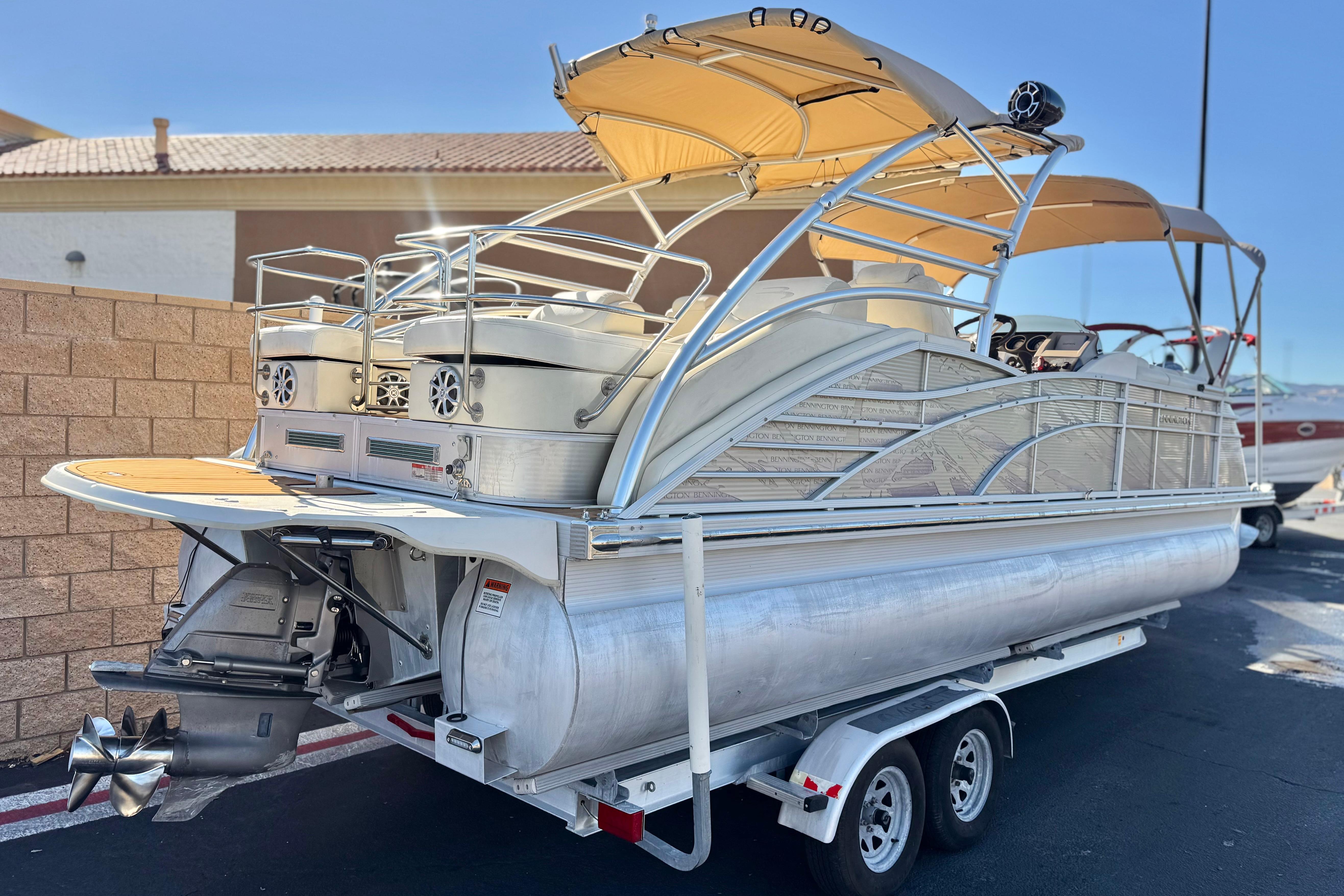 2013 Bennington 2575QCW I/O pontoon boat with canopy on a trailer.