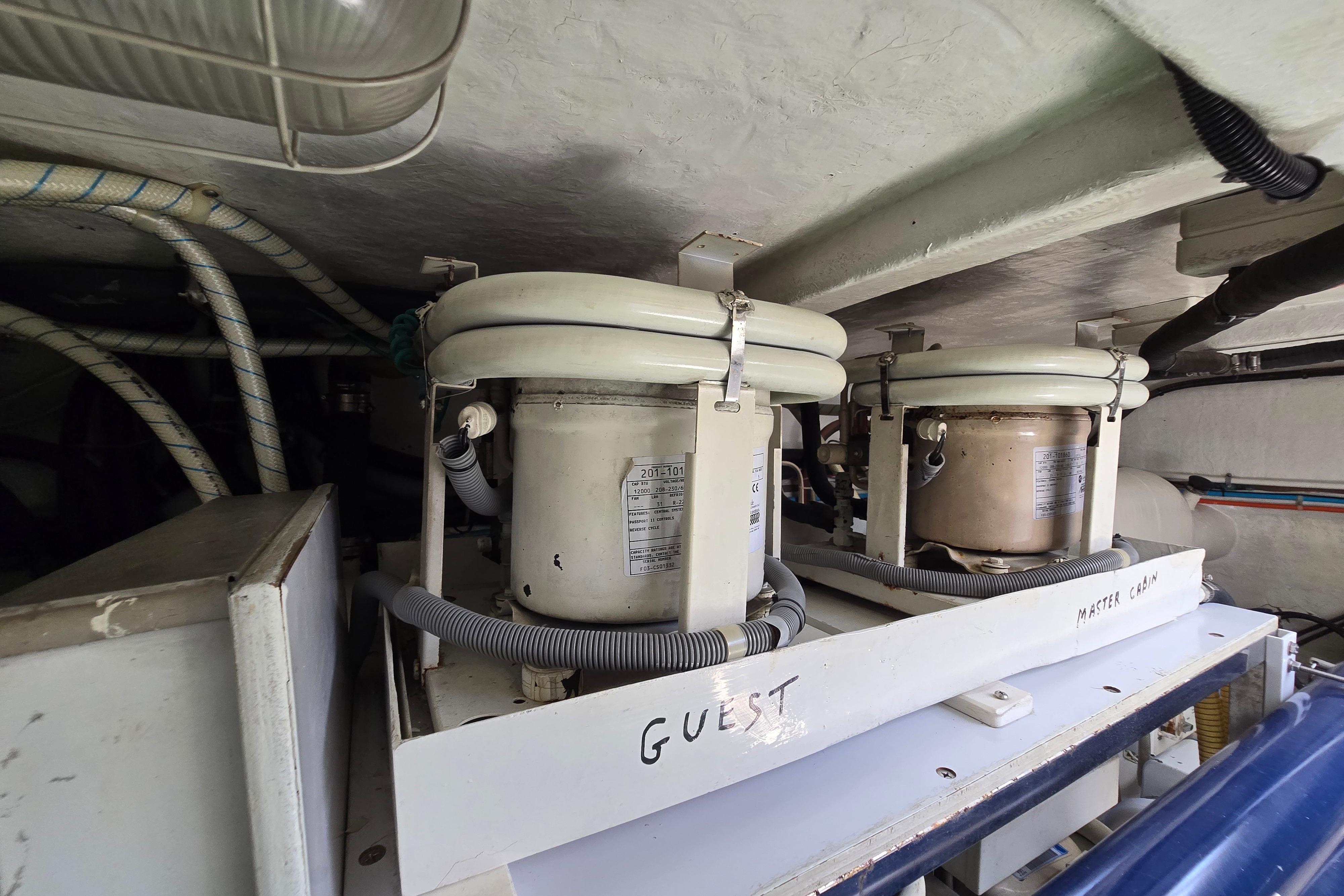 Engine room of 2004 Grand Harbour 58 yacht with labeled equipment and wiring.