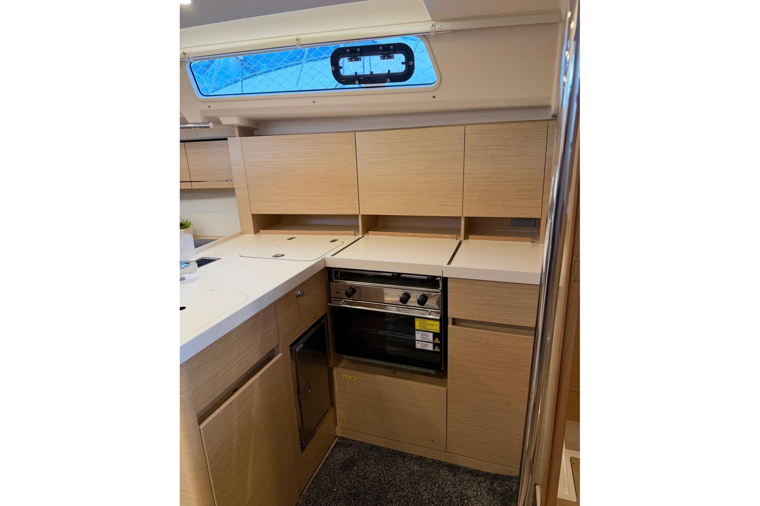 Modern kitchen interior of 2022 Hanse 418 yacht with sleek cabinetry and appliances.