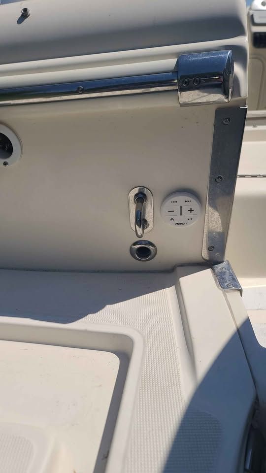 Close-up of a boat part with stainless steel fittings and controls.