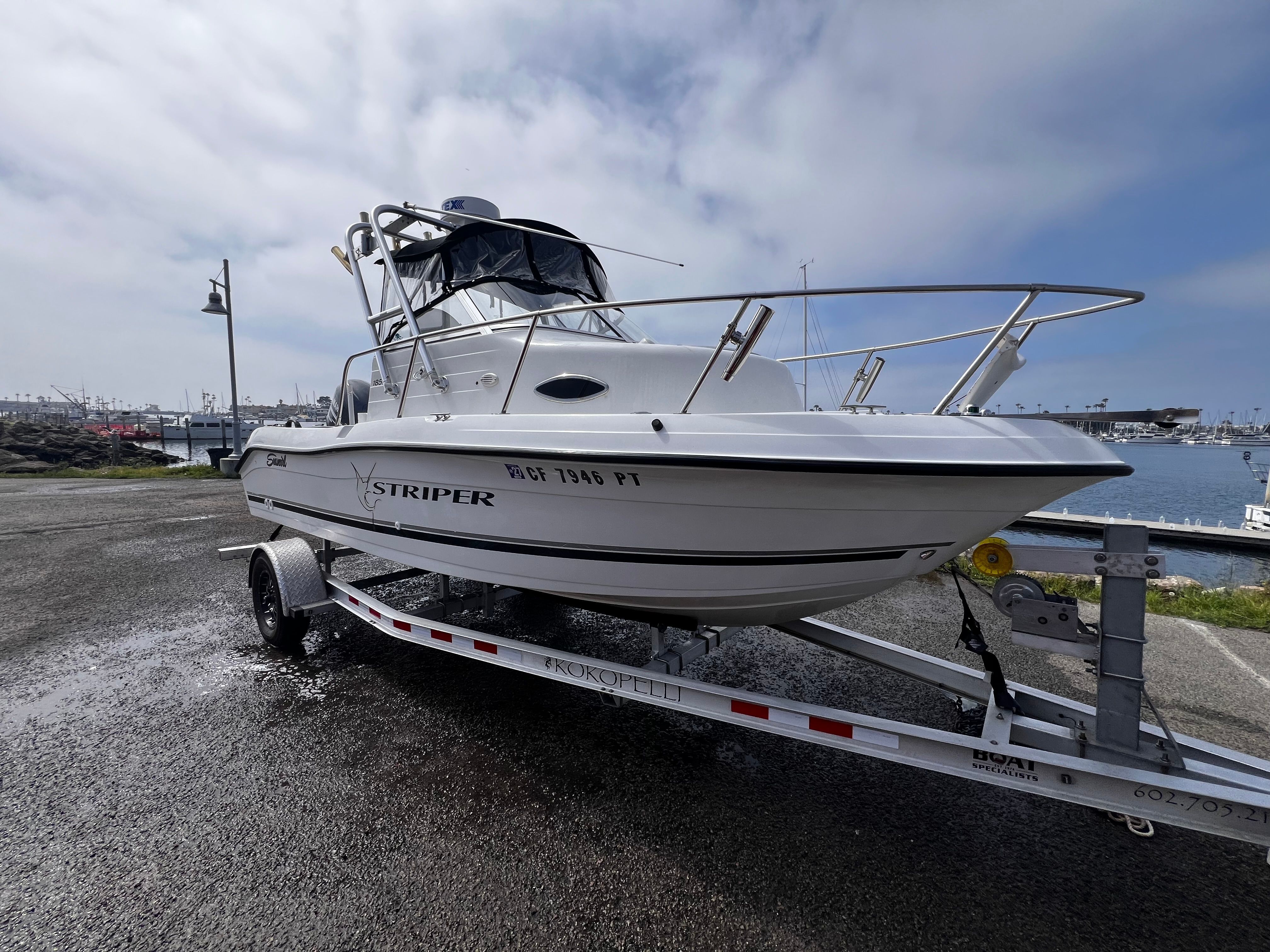 A 2001 Seaswirl Striper 1851 WA on a trailer, ready for launch at the harbor.