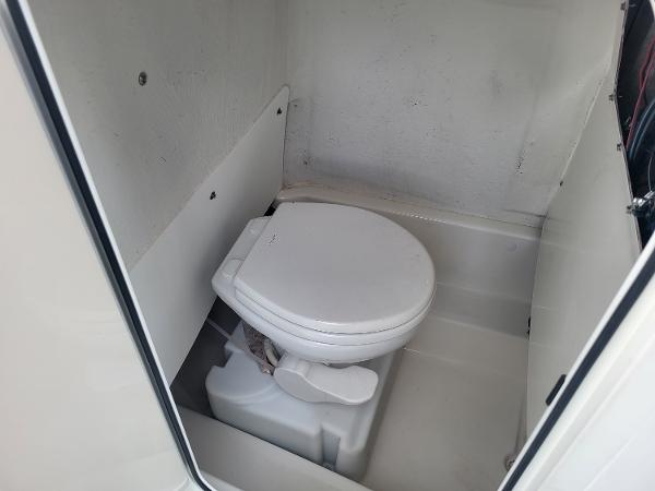 2021 NauticStar 2302 Legacy boat interior with marine toilet.
