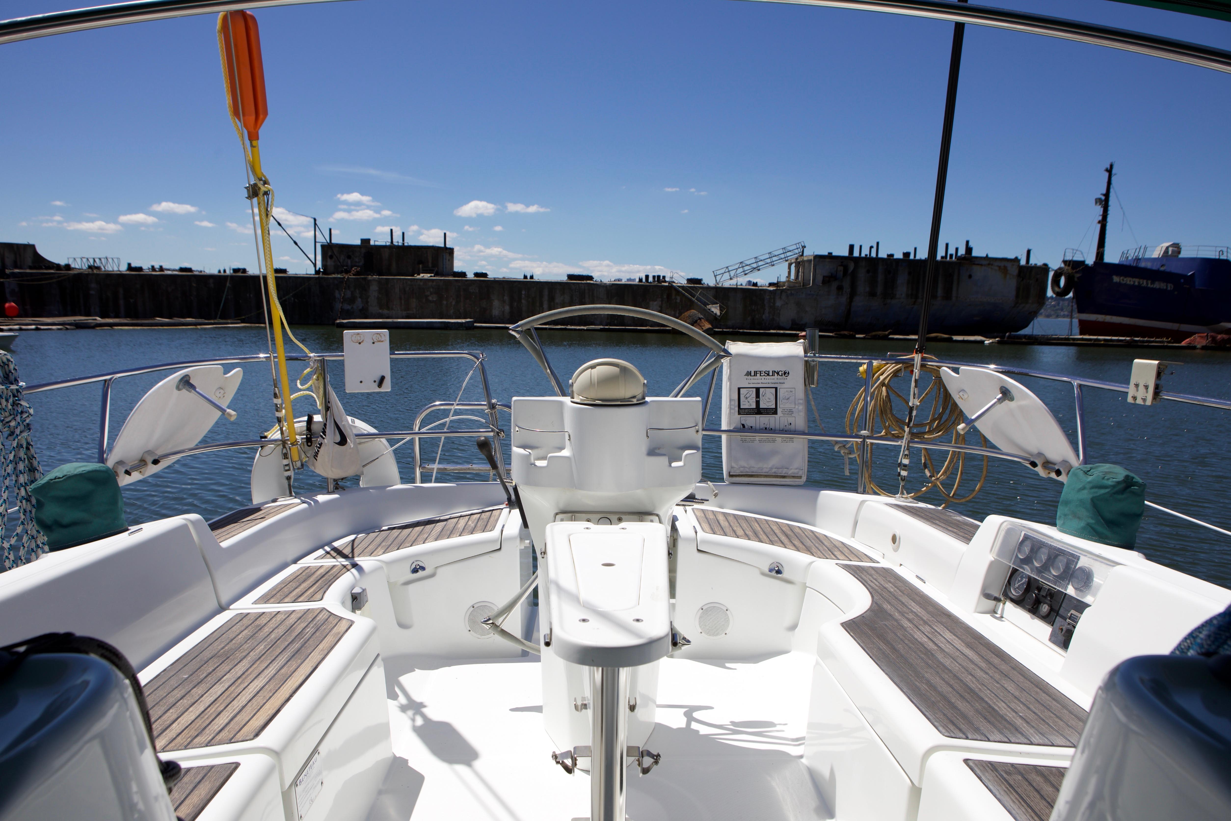 Cockpit view of 2005 Beneteau 423 sailboat docked in a marina.