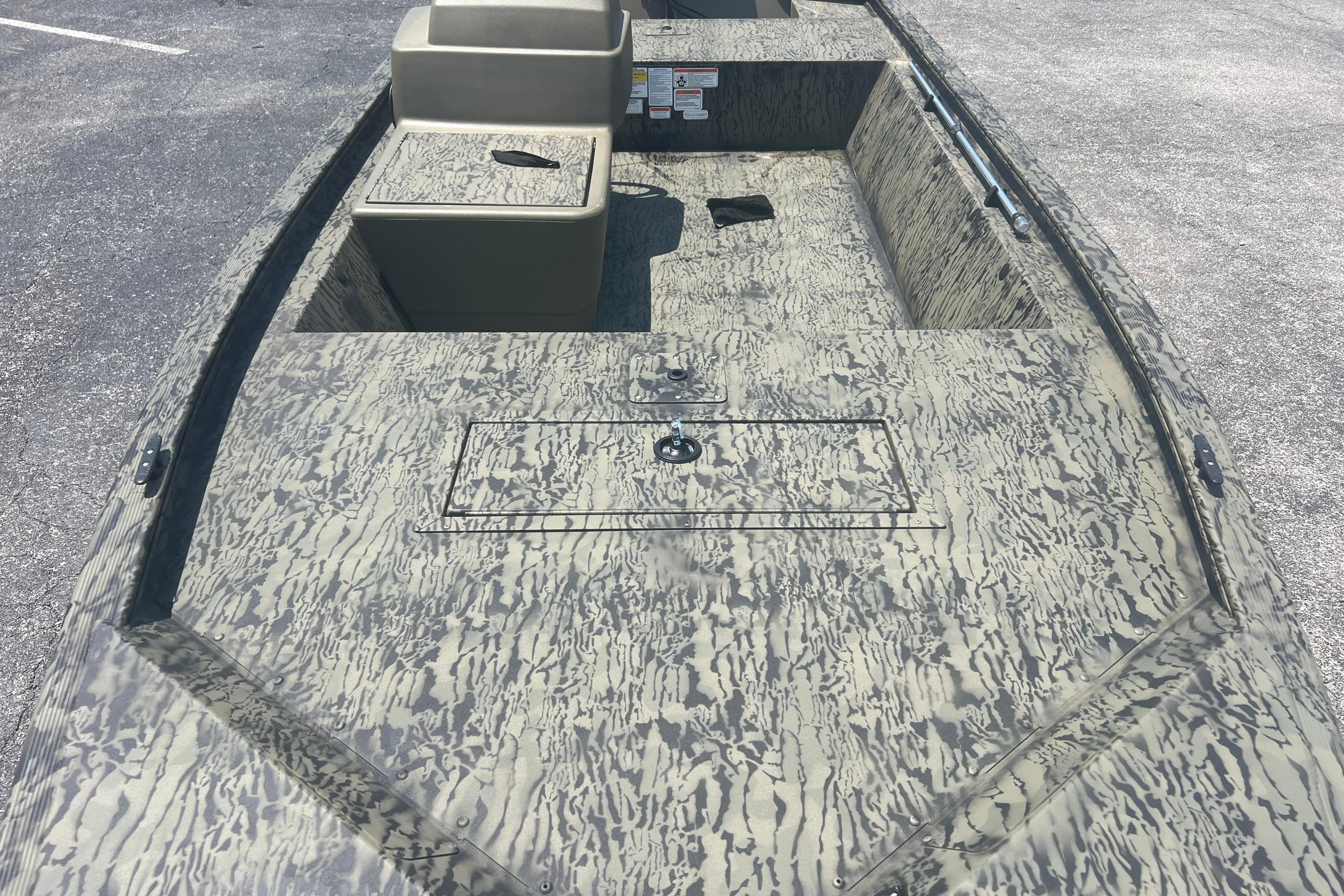 2026 Tracker Grizzly 1648 SC boat with camouflage pattern, spacious interior, and storage compartments.