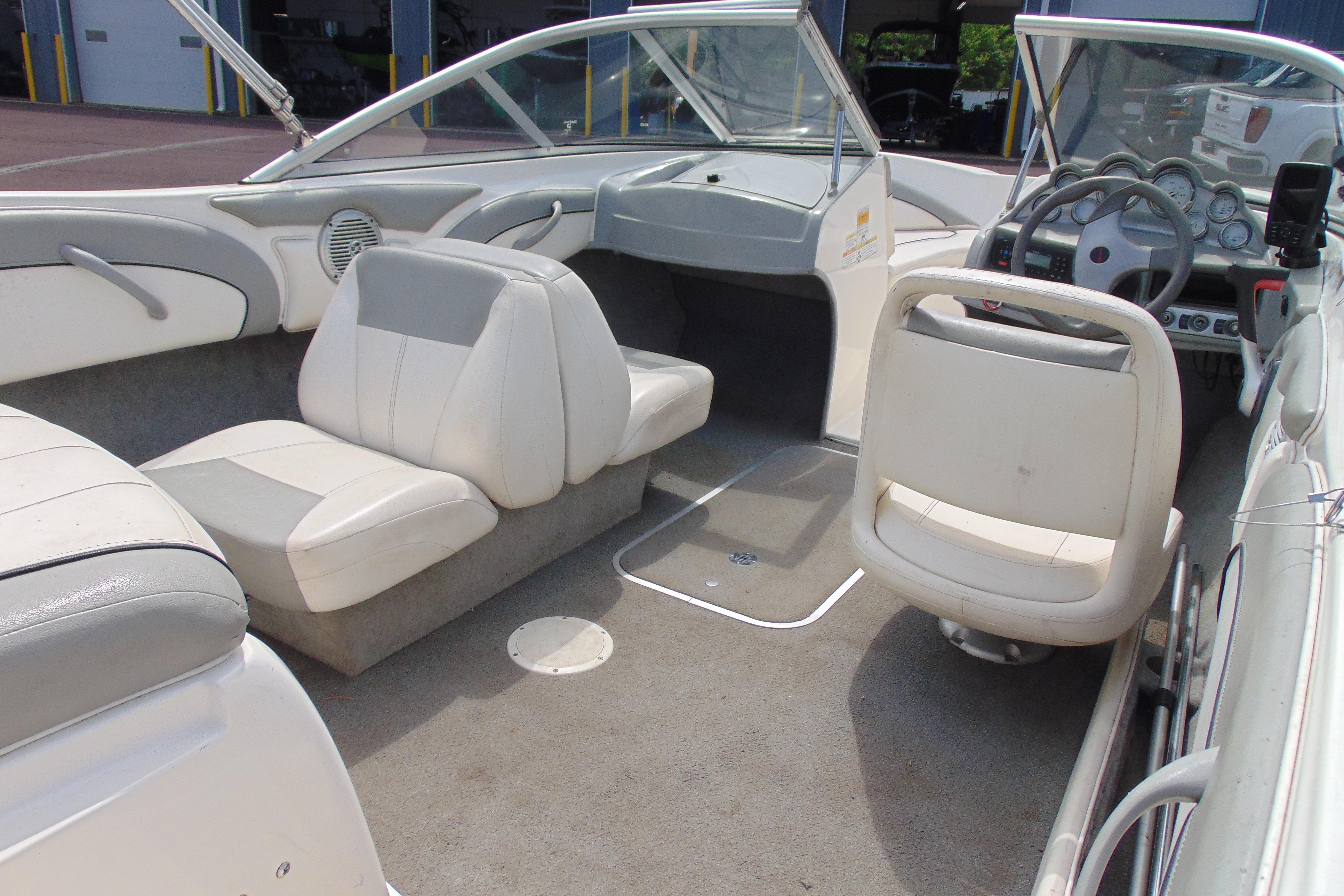 2012 Bayliner 185 Bowrider interior with white seating and steering console.