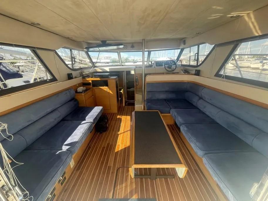 Interior of 1985 Princess Sedan Flybridge yacht with blue seating and wooden flooring.