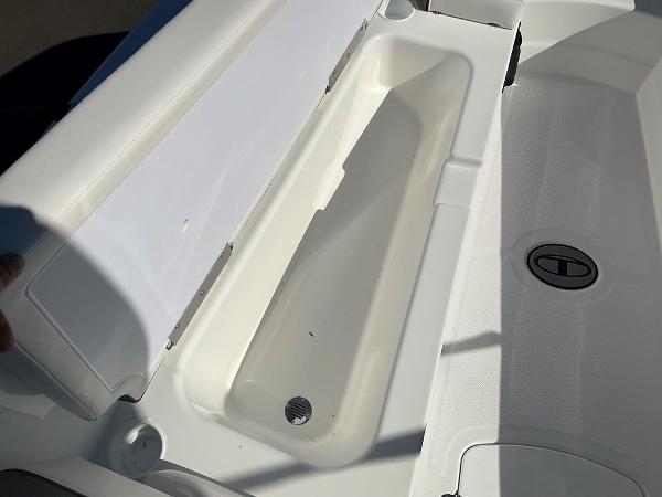 2025 Tahoe T18 boat storage compartment with open lid, showcasing interior space.