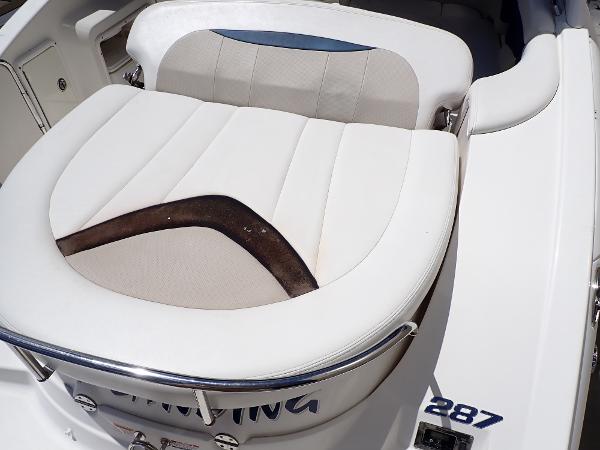 2011 Chaparral 287 SSX boat seat with white and beige upholstery.