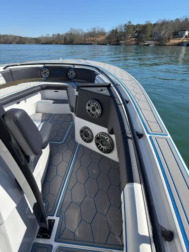 2024 Fountain 34 SC boat interior with sleek seating and modern speaker system on a calm lake.