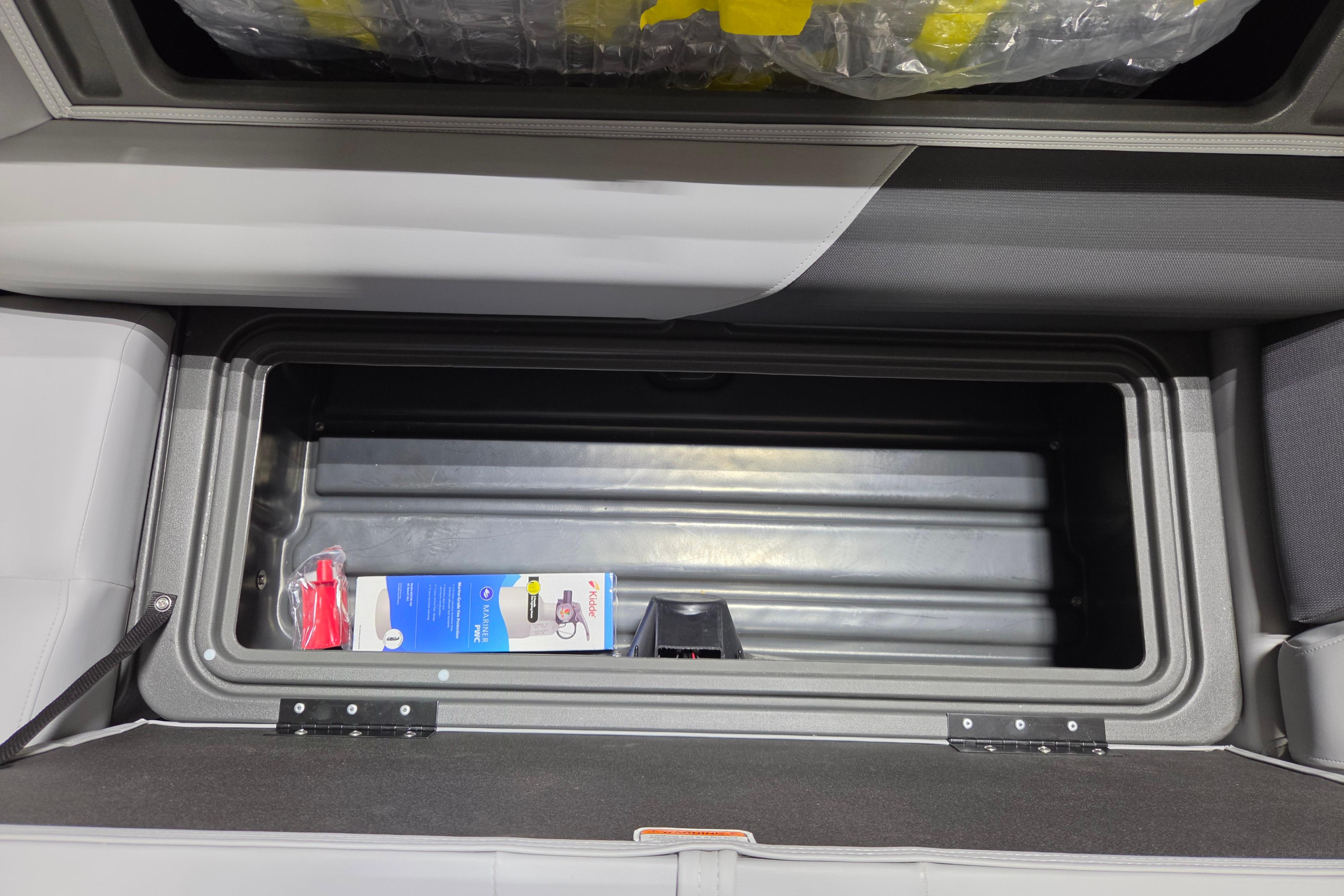 Storage compartment of 2026 Sun Tracker Party Barge 20 DLX with accessories inside.