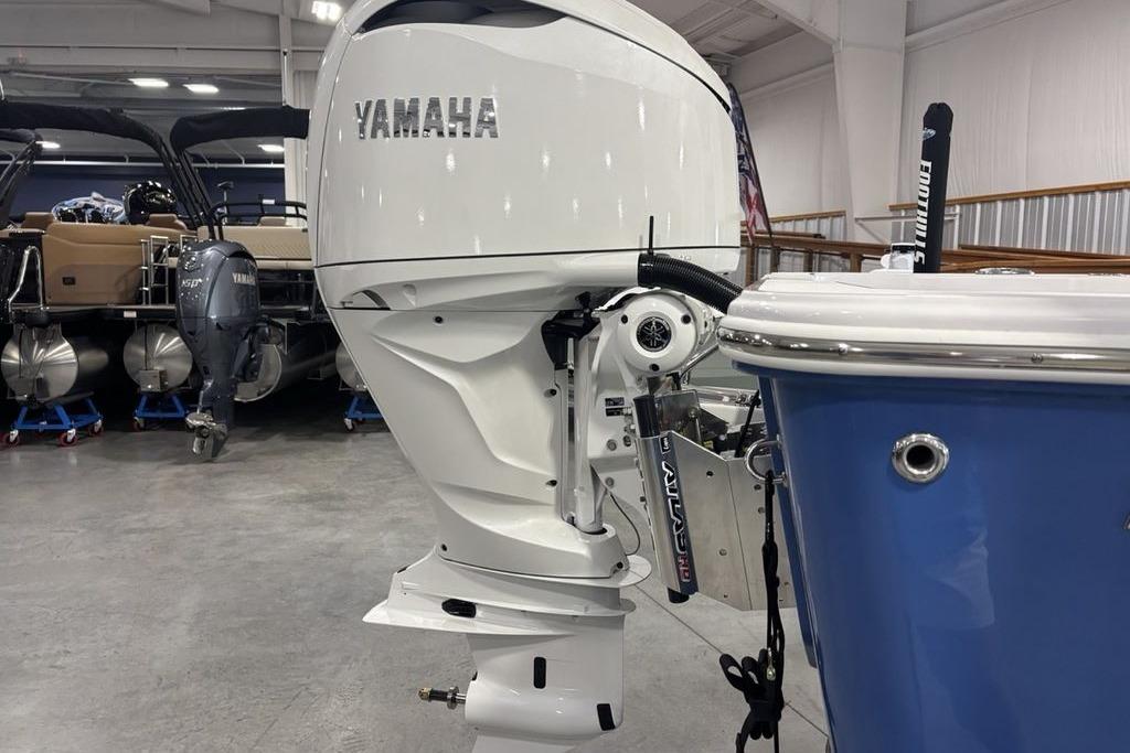 2026 Sportsman Masters 247 Bay Boat with Yamaha outboard engine in showroom.