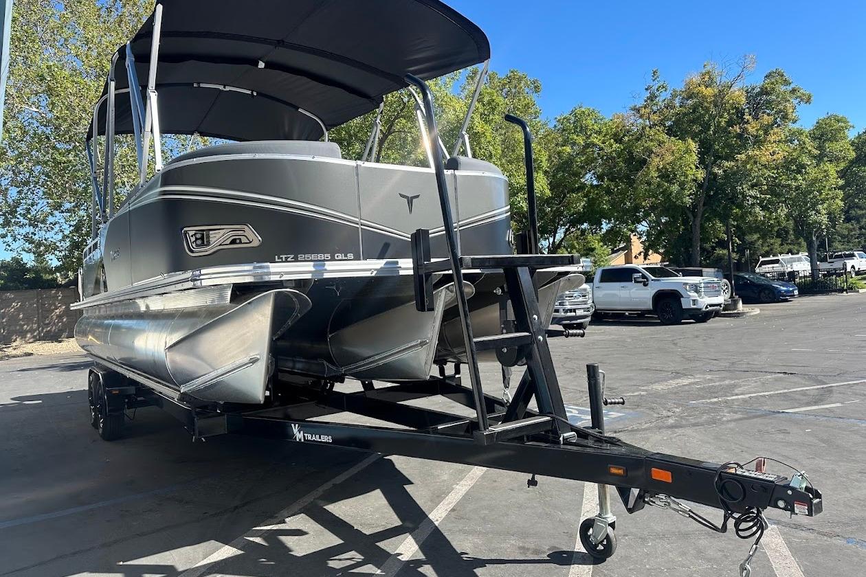 2026 Tahoe Pontoon LTZ Quad Lounger Shift 23 on trailer in parking lot.