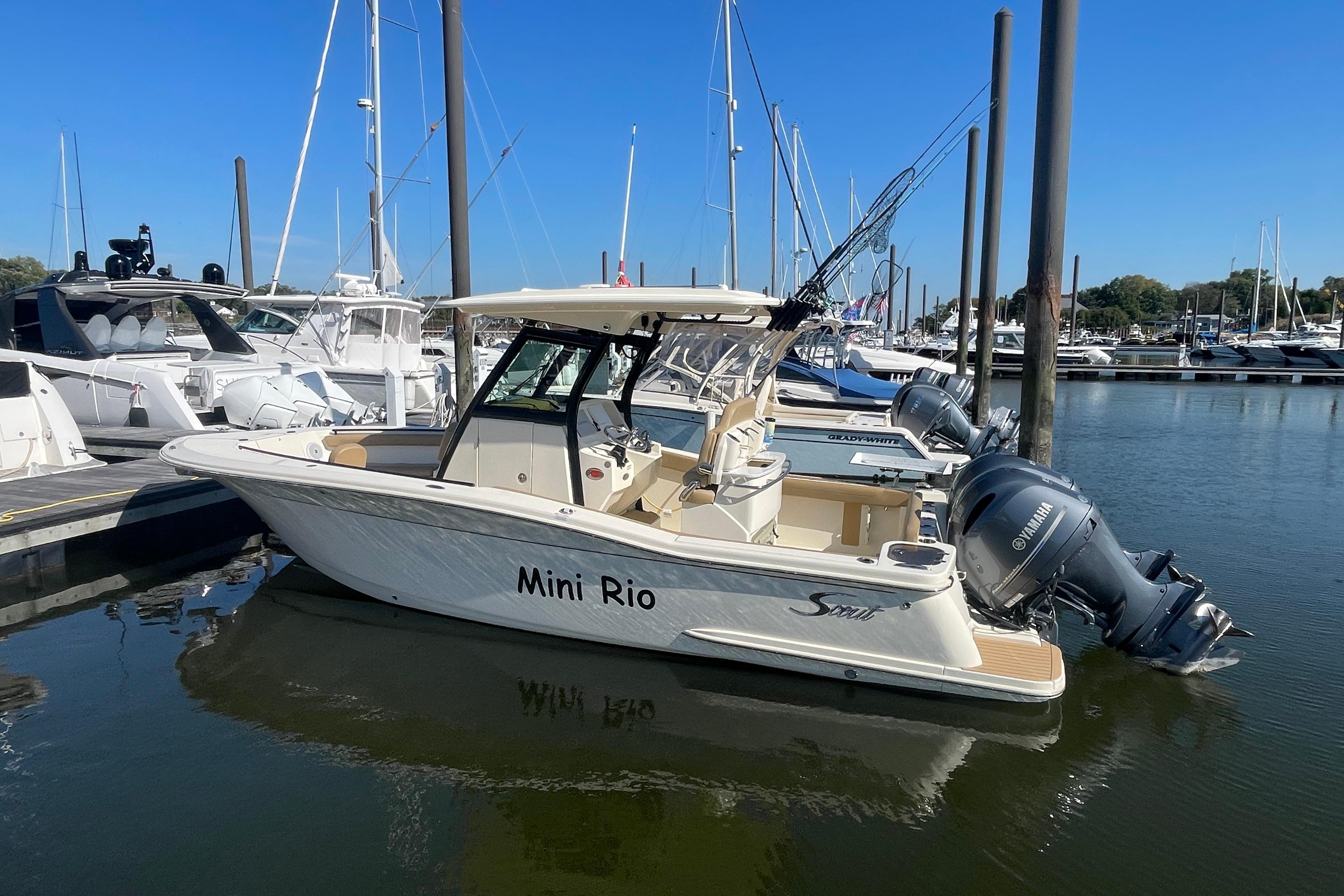 2020 Scout 255 LXF boat docked in marina, featuring twin Yamaha engines.