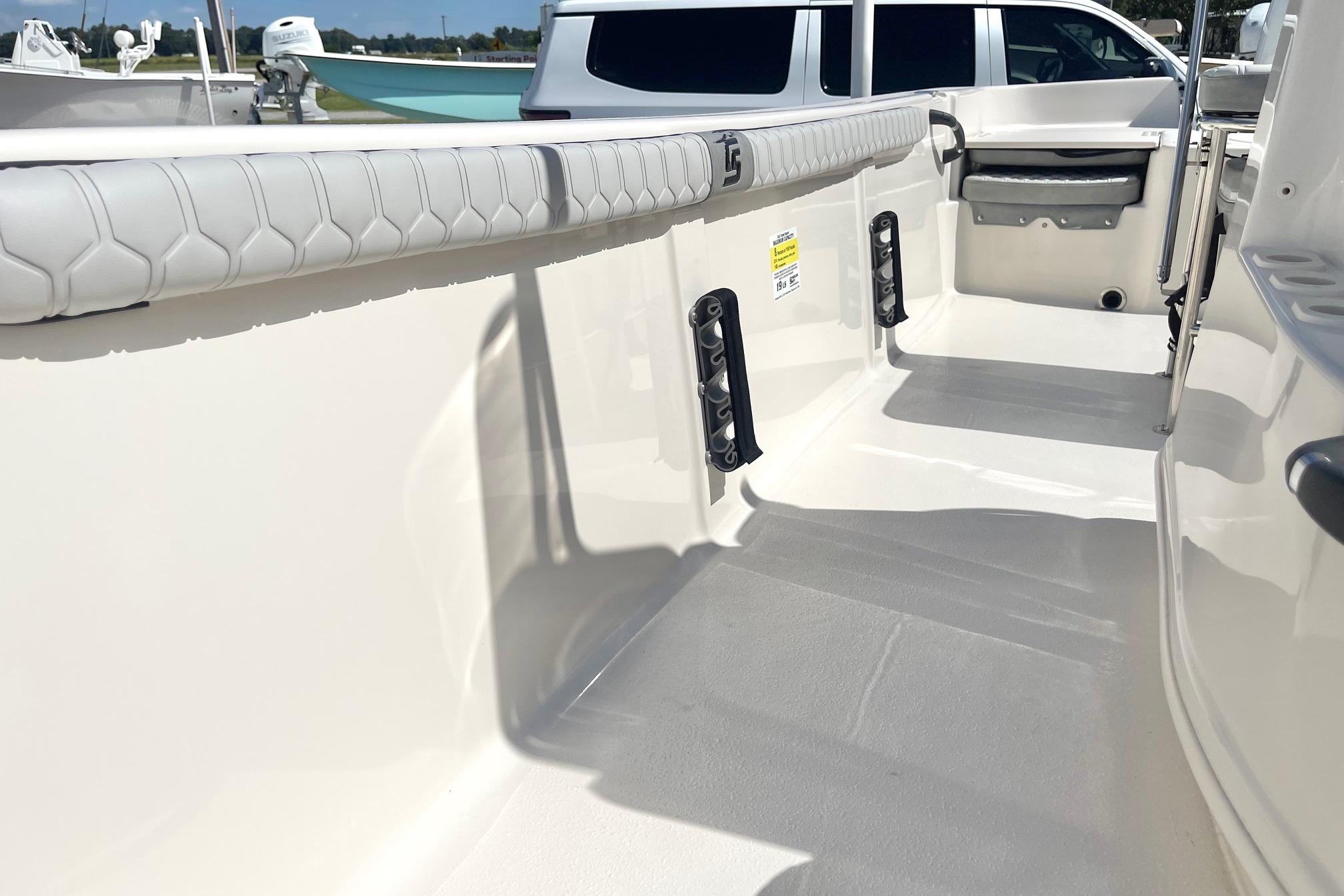 2026 Carolina Skiff 19 LS boat interior with padded seating and storage compartments.