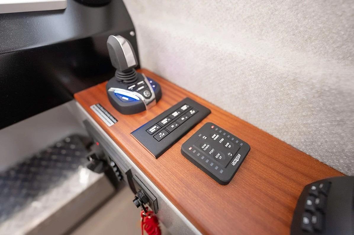 Control panel of 2026 KingFisher 3225 GFX Offshore boat with joystick and switches.