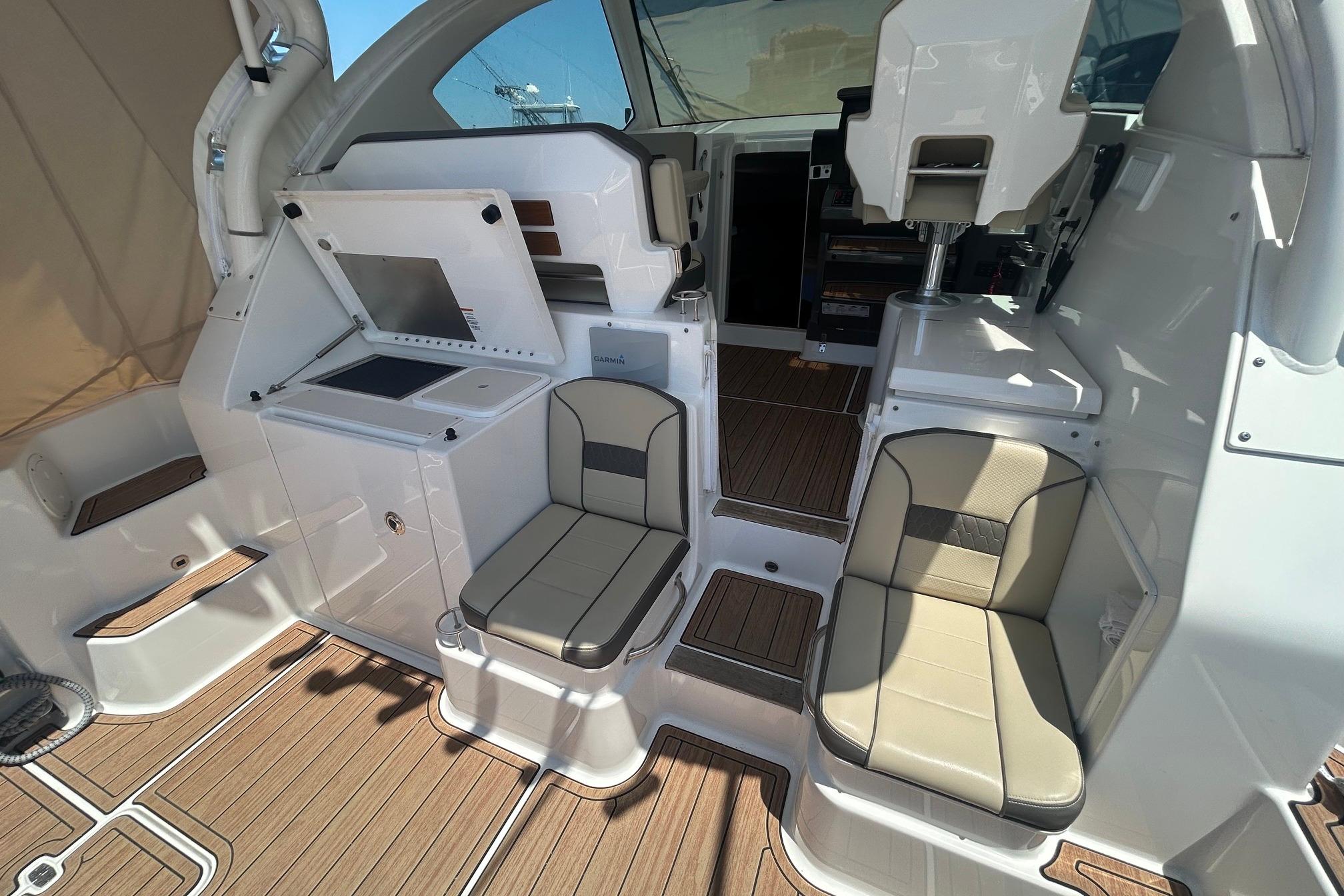 2019 Pursuit OS 355 Offshore boat interior with seating and helm station.